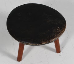 Arne Hovmand Olsen ottoman in black patinated leather and teak. 1960s