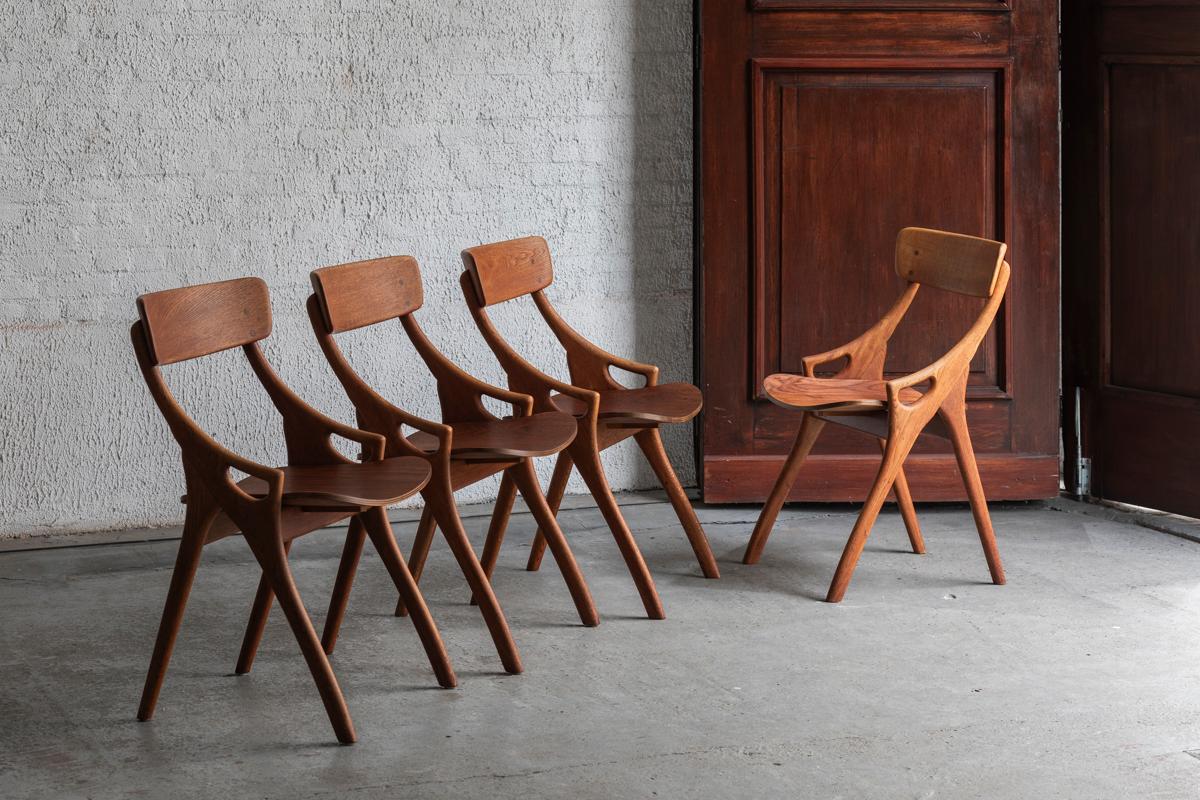 Set of 4 dining chairs designed by Arne Hovmand Olsen and produced in Denmark around 1960. Solid oak frame and a plywood veneer seat. In good condition with some small using marks as shown in the pictures. One small crack in one of the handles has