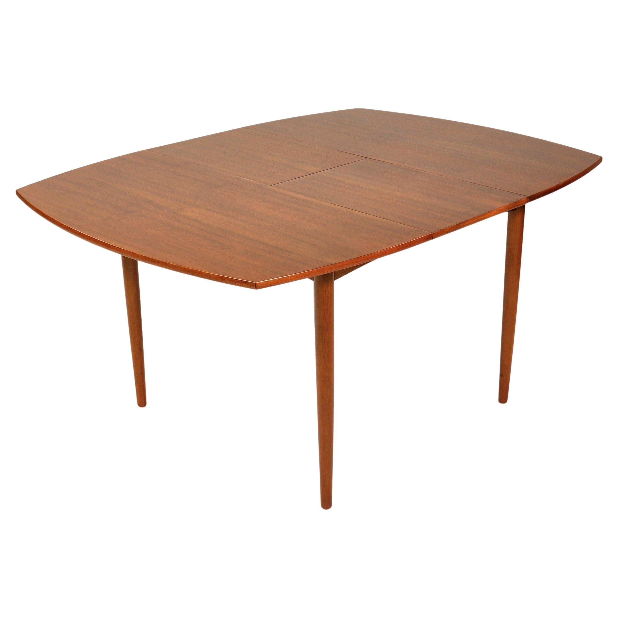 Gorgeous mid-century Scandinavian Modern teak dining table, designed by Arne Hovmand Olsen in the 1960s for Mogens Kold Møbelfabrik. The table seats four when compact and extends to accommodate six for a larger dinner party. The clean lines of the