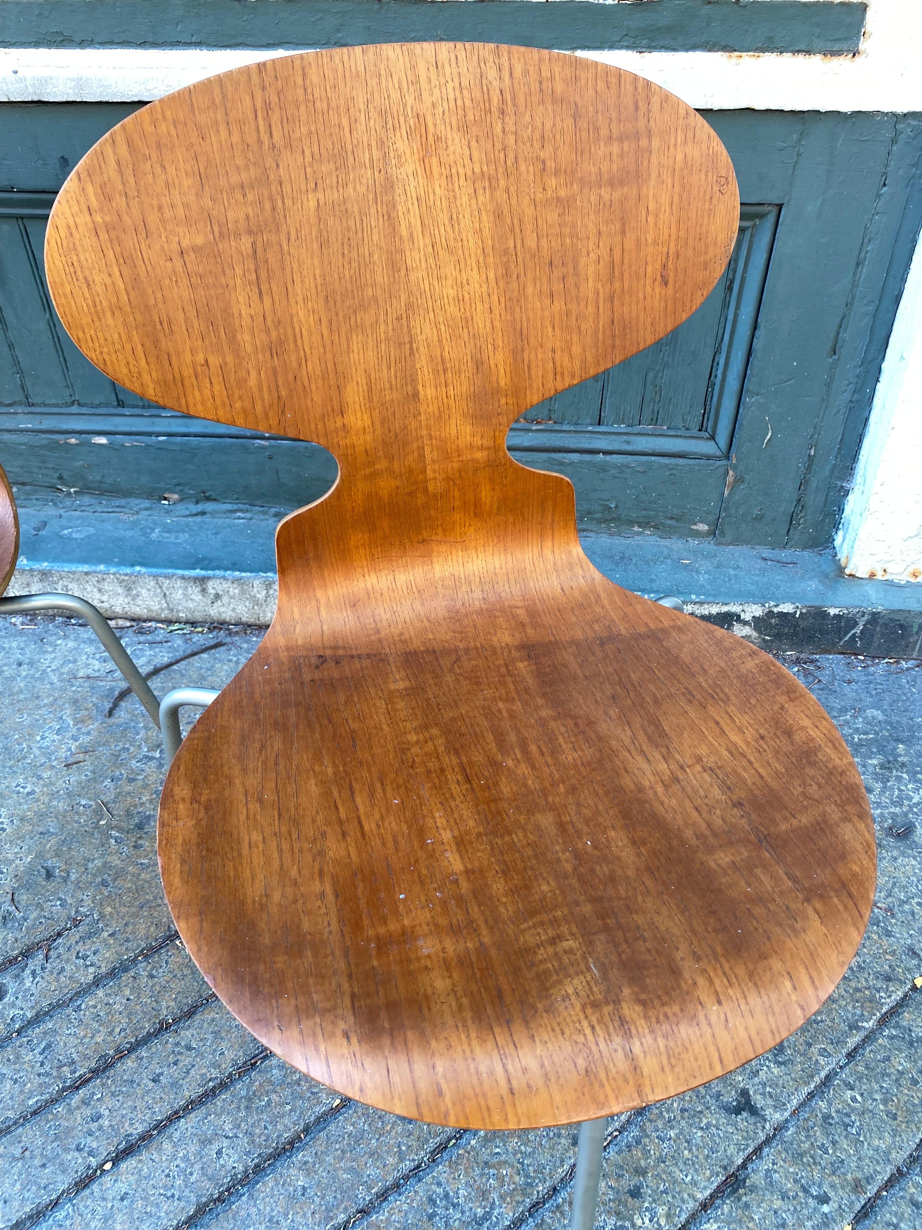 Pair of Arne Jacobsen Teak Ant Chairs. Overall very nice shape, signs of shadow on one seat area as seen in photo. Spines are in good shape and no veneer chips! Chairs stack!