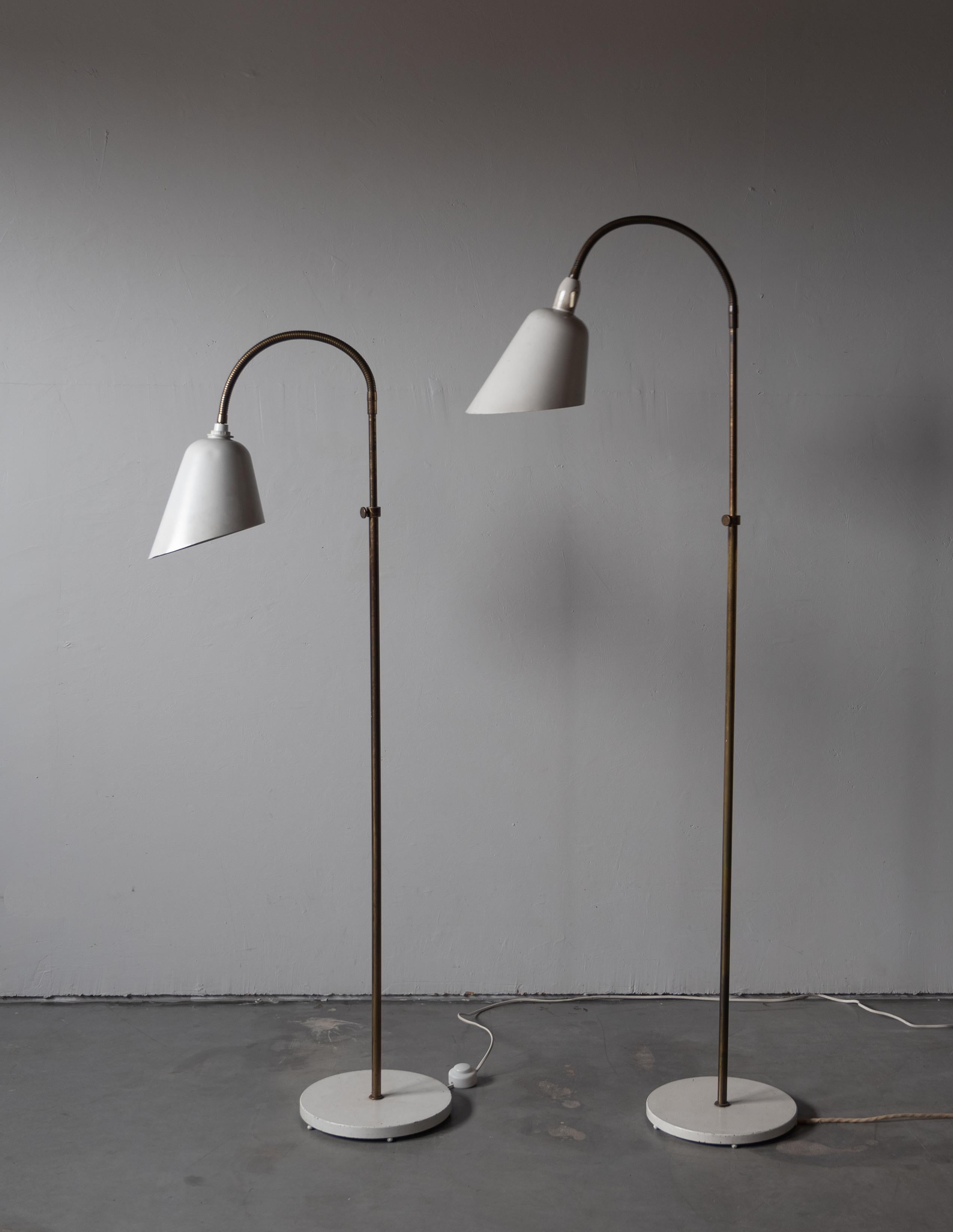 A pair of early production adjustable floor lamps. Designed by Arne Jacobsen in 1929, produced by Louis Poulsen, Denmark, c. 1930s-1940s.

Features lacquered metal and brass. 

Dimensions variable. Mounting for metal lampshades varies on each