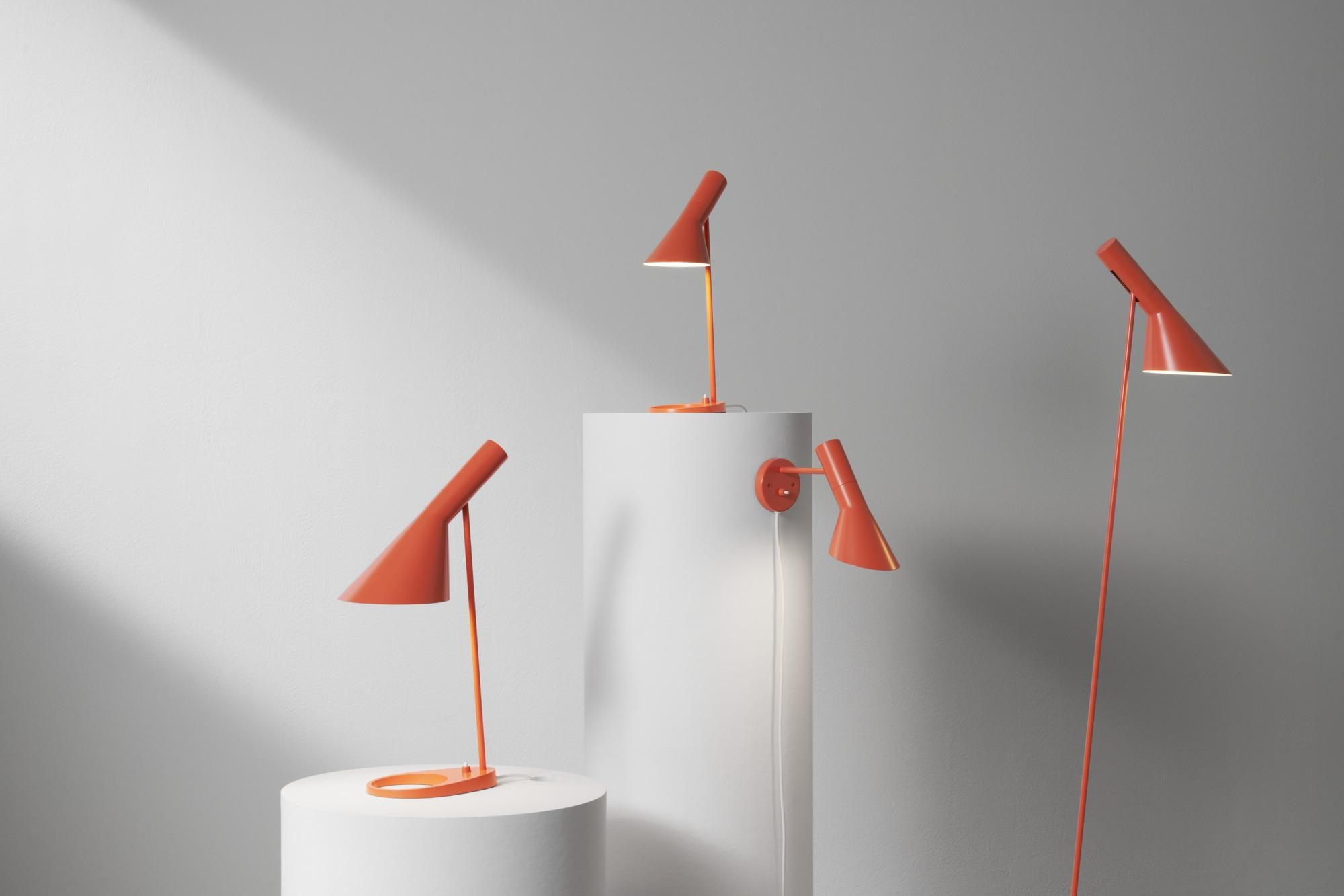 Arne Jacobsen AJ Floor Lamp in Electric Orange for Louis Poulsen.

The AJ series was part of the lighting collection renowned Danish designer Arne Jacobsen created for the original SAS Royal Hotel in 1957. Today, his furniture and lighting designs