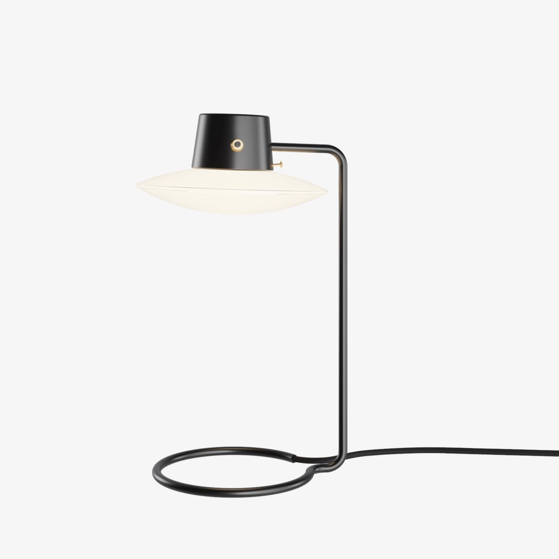 Arne Jacobsen AJ Oxford Table Lamp 410mm in black and opaline for Louis Poulsen. Designed in 1963, current production.

The AJ Oxford Table Lamp has a sleek graphic expression, which reflects the architecture of St Catherine's College, in Oxford,