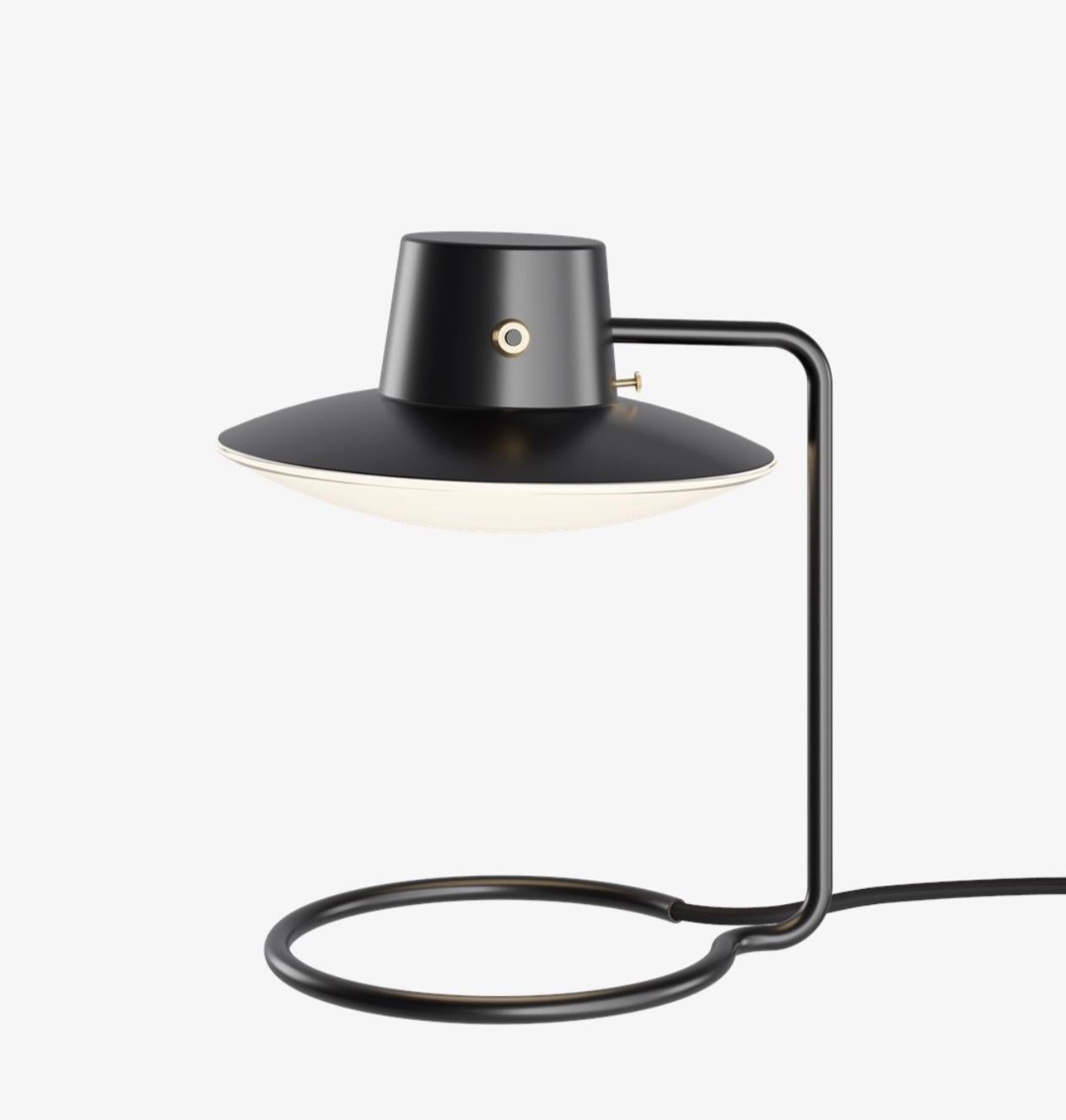 Arne Jacobsen AJ Oxford table lamp 28mm 410mm in black and opaline for Louis Poulsen. Designed in 1963, current production.

The AJ Oxford table lamp has a sleek graphic expression, which reflects the architecture of St Catherine's College, in