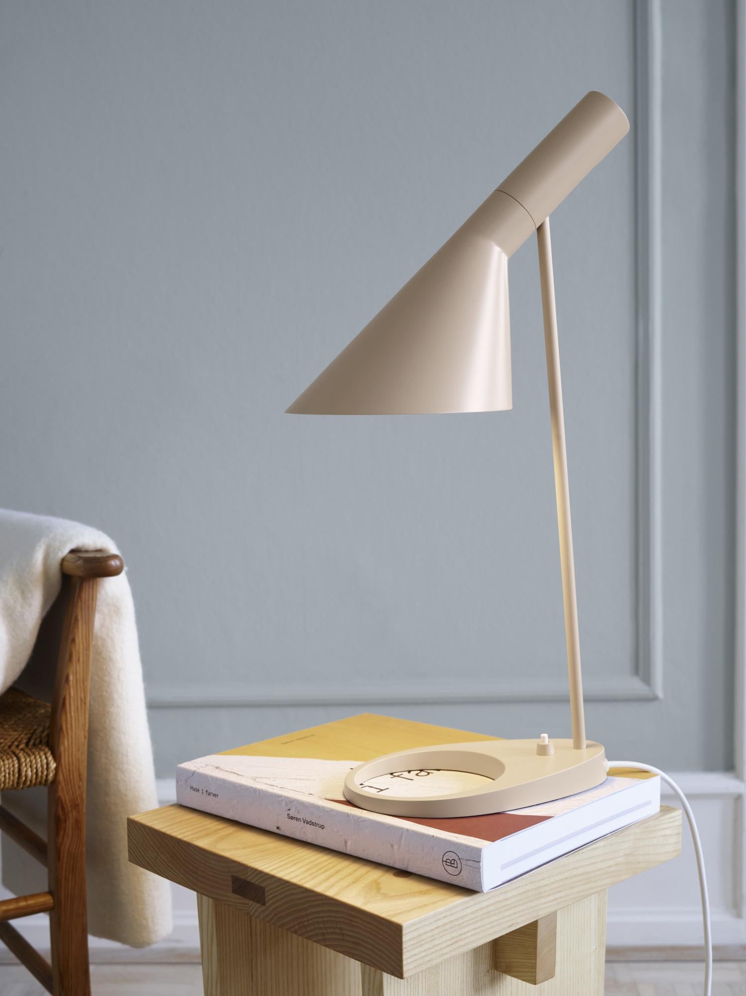 Arne Jacobsen AJ table lamp in Warm Sand for Louis Poulsen. 

The AJ series was part of the lighting collection renowned Danish designer Arne Jacobsen created for the original SAS Royal Hotel in 1957. Today, his furniture and lighting designs are