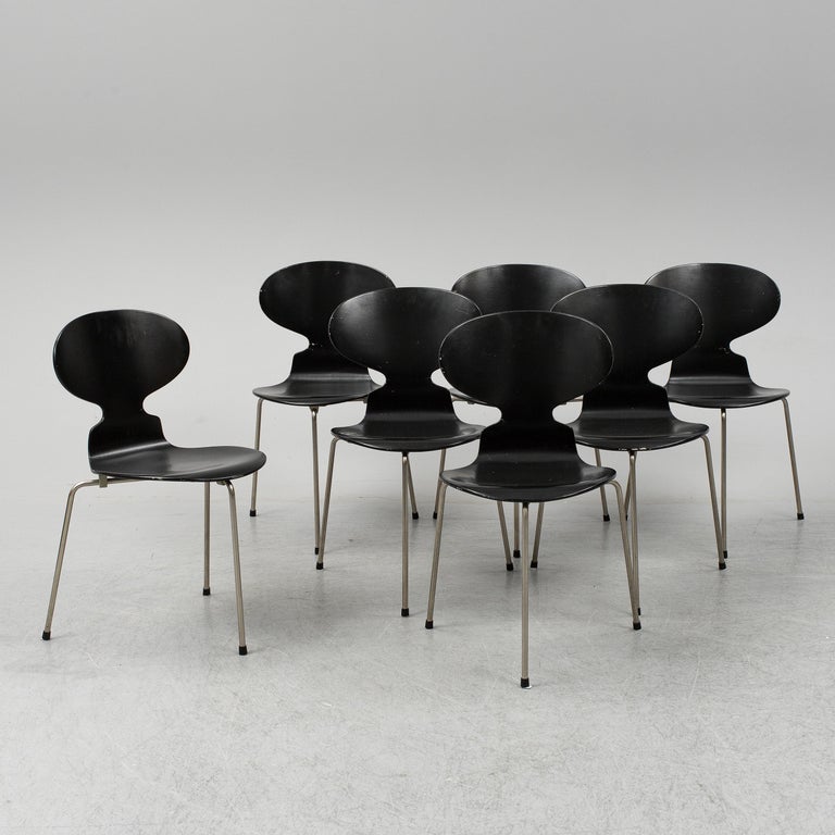 Early pieces of the iconic 'Ant' chairs designed by Arne Jacobsen in 1952. Stackable three-legged dining chairs model 3100 made by Fritz Hansen in Denmark. This set was produced in beginning of 1950s. Black lacquered bentwood on steel frame.