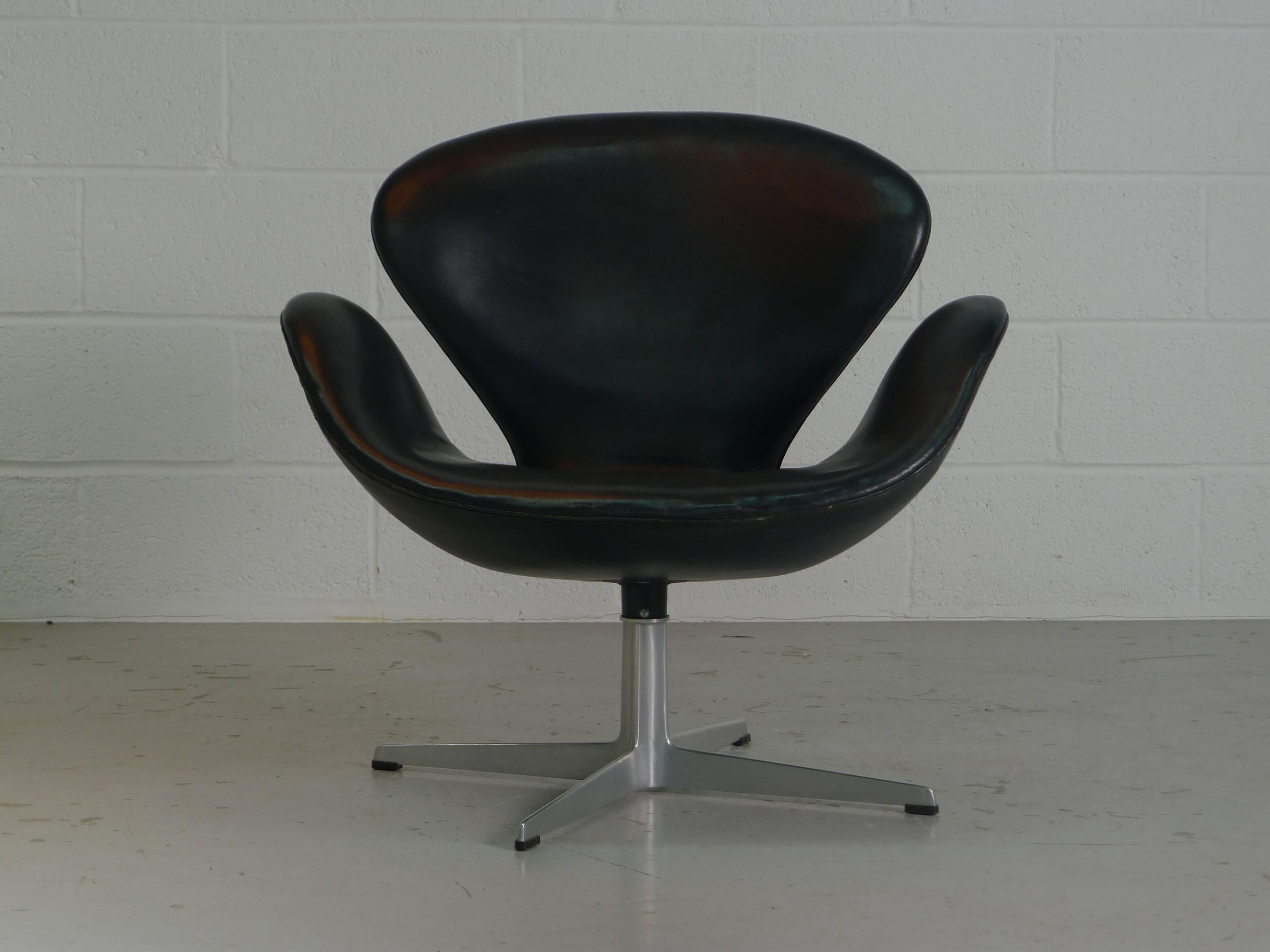 Arne Jacobsen, Denmark. A black Swan chair retaining it's original leather, manufactured by Fritz Hansen September 1966 and labelled as such to the underside.
The leather is over 50 years old but presents beautifully, nicely patinated but no holes,
