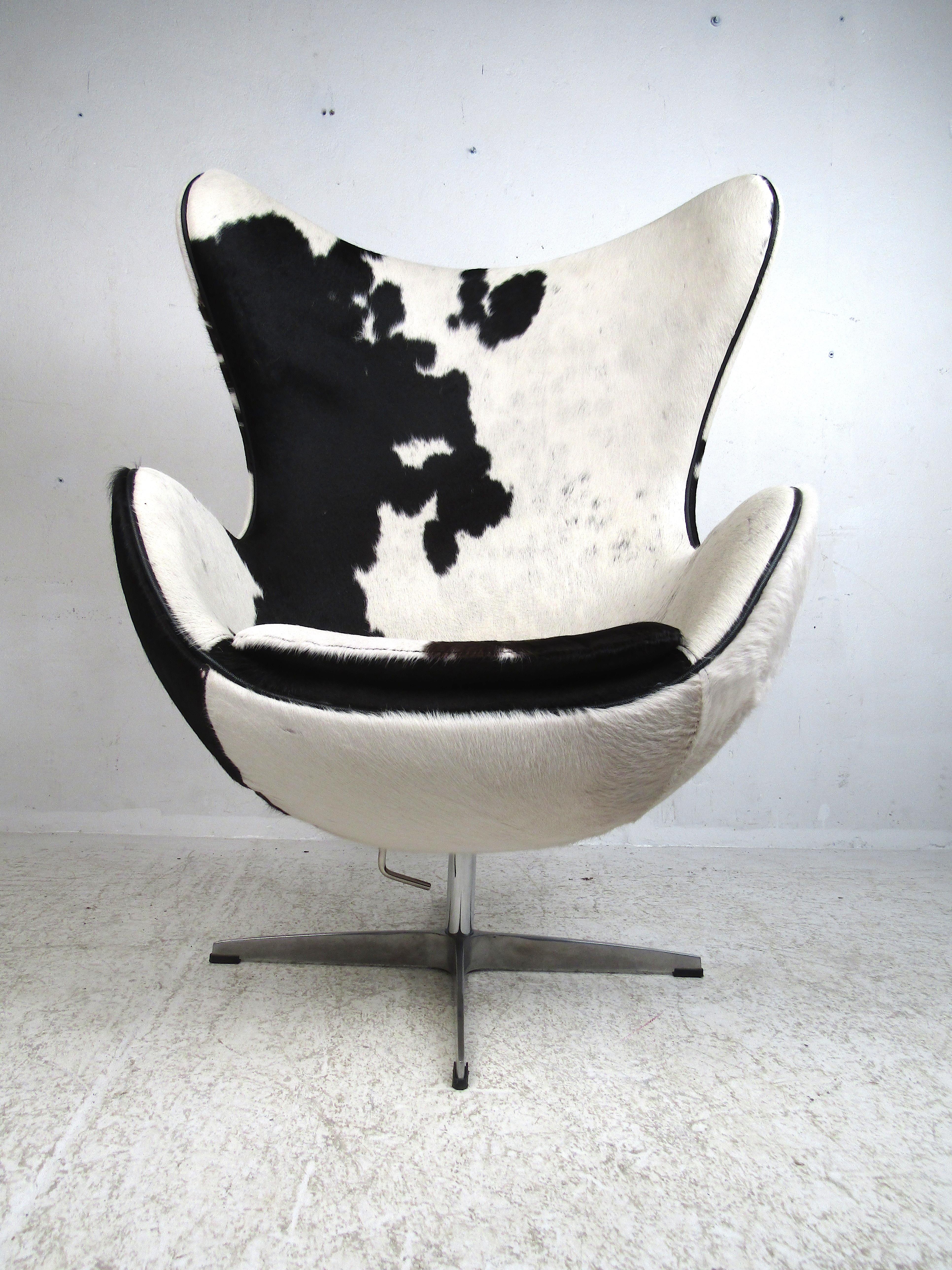 Danish modern cow-hide egg chair, famous design by Arne Jacobsen. Sturdy and comfortable chair. This piece is sure to make an impressive addition to any modern interior's seating arrangement. Please confirm item location with dealer (NJ or NY).
