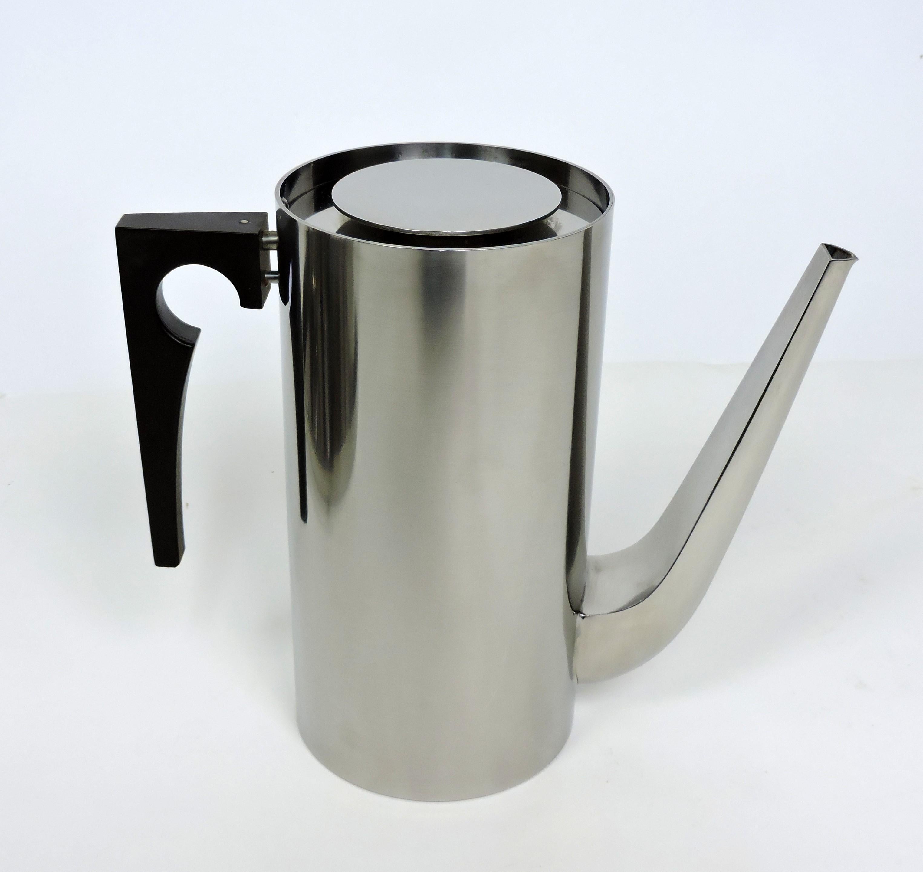 Handsome Cylinda Line coffee and tea service designed in 1967 by Arne Jacobsen and made in Denmark by Stelton. This set includes - a lidded coffee pot, a lidded teapot, a lidded sugar bowl with spoon, a creamer, and a round tray with handles.
