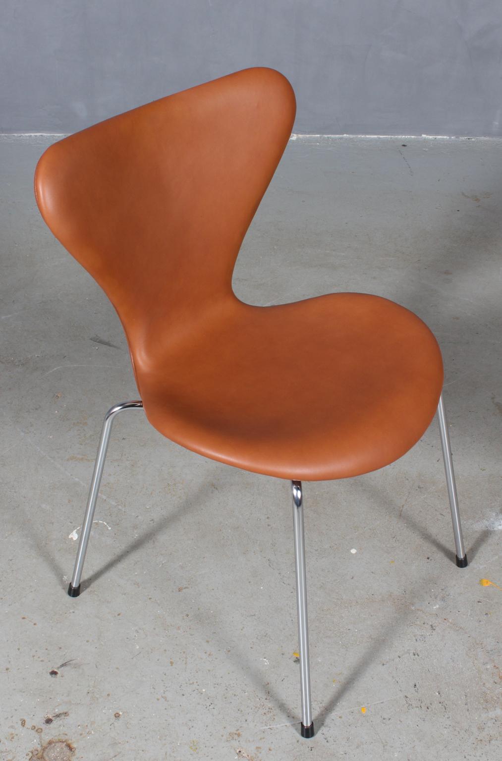 Arne Jacobsen dining chair new upholstered with cognac pure aniline leather.

Base of chrome steel tube.

Model 3107 Syveren, made by Fritz Hansen.