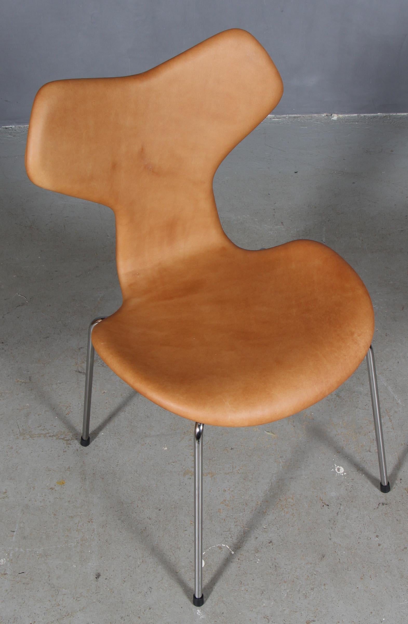 Arne Jacobsen dining chair new upholstered with cognac vintage aniline leather.

Base of chrome steel tube.

Model 3130 Grand Prix, made by Fritz Hansen.