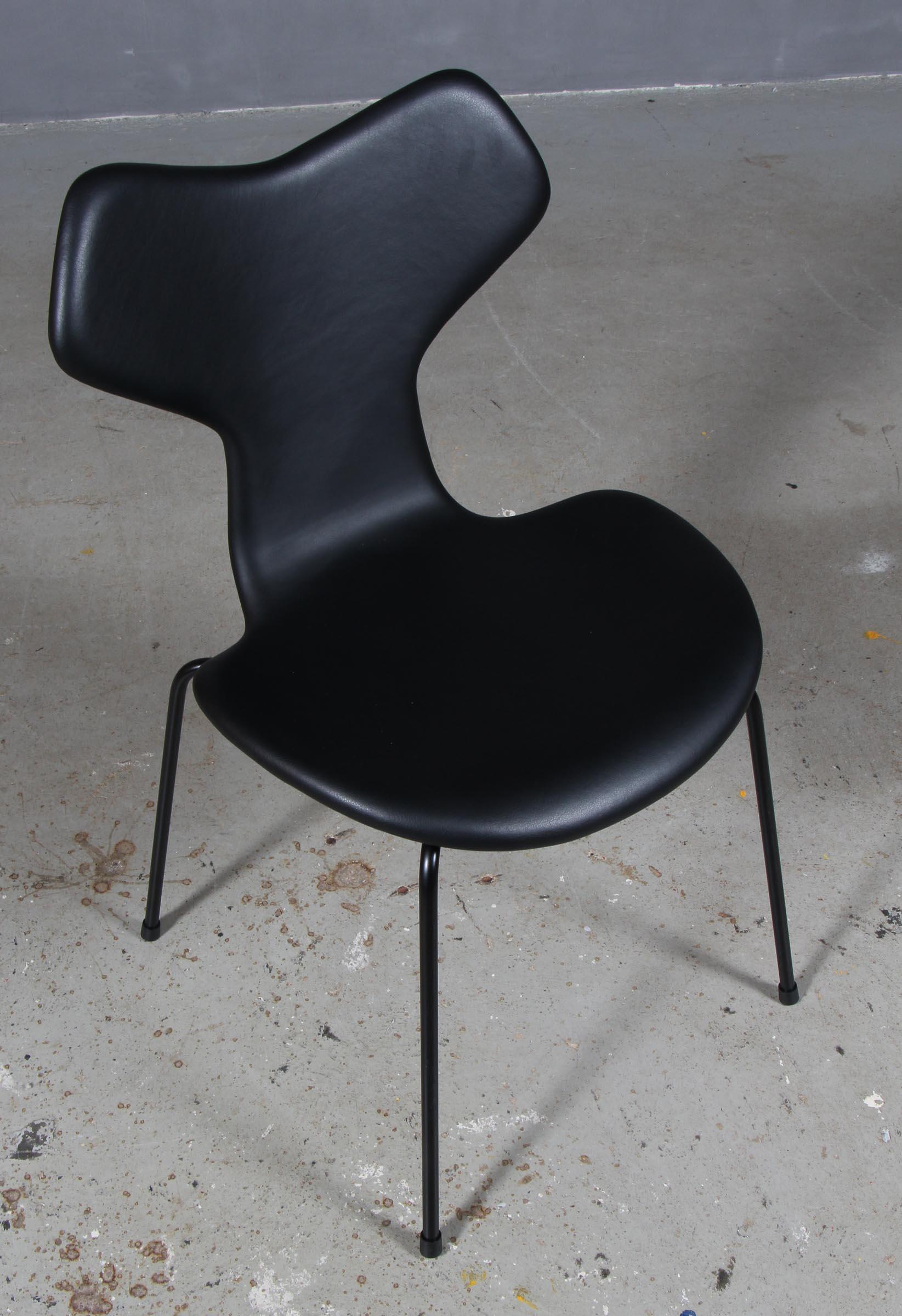 Arne Jacobsen dining chair new upholstered with black aniline leather.

Base of powder coated steel tube.

Model 3130 Grand Prix, made by Fritz Hansen.
