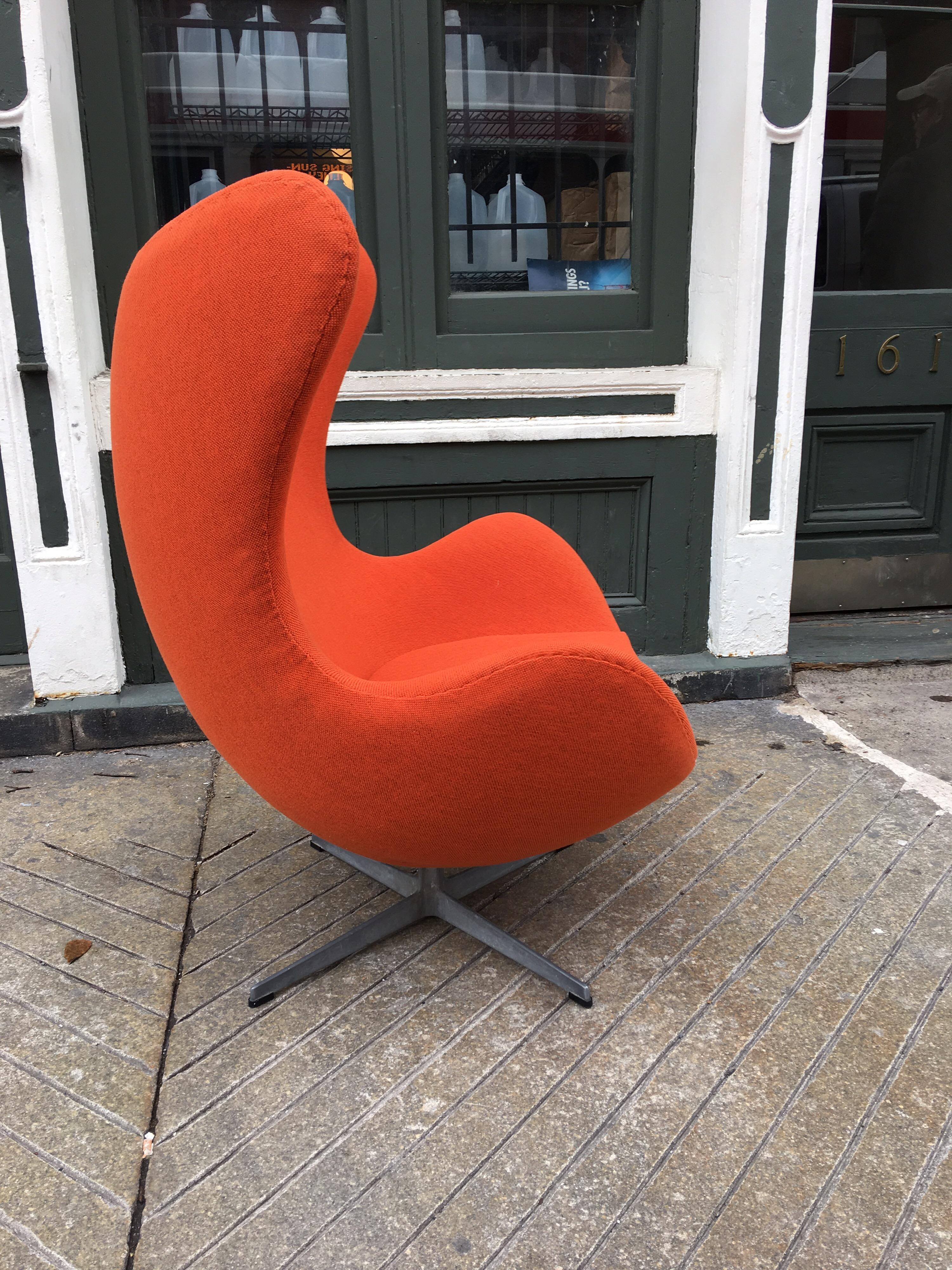 Newly reupholstered Egg chair by Arne Jacobsen for Fritz Hansen. This is an older model with the stem made up of concave sides instead of the simple newer model of a round stem. This chair also has the reclining mechanism which is always an added
