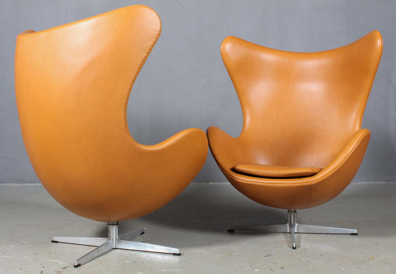 Arne Jacobsen set of lounge chairs model Egg. New upholstered with Dakar tan aniline leather.

Four star profilated base.

Made by Fritz Hansen.

These chairs comes from Hotel Royal which Arne Jacobsen was architect for. Most of his iconic