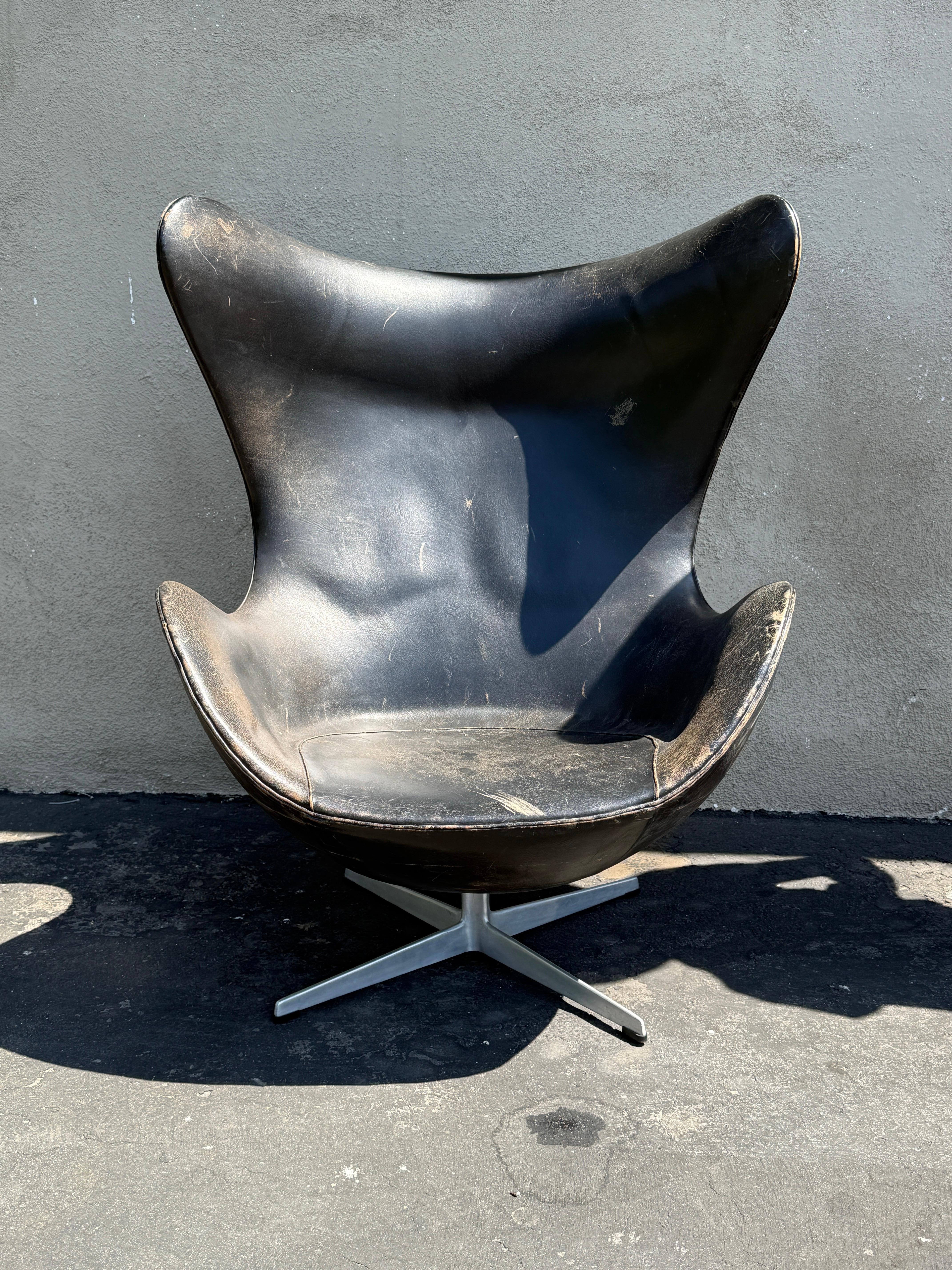 Arne Jacobsen  first edition egg chair designed in 1958 for SAS hotel Copenhagen and made by Fritz Hansen. Chair retain FH stamp and original label on the bottom. Leather is absolutely beautiful with worn heavy patina. You can feel foam is