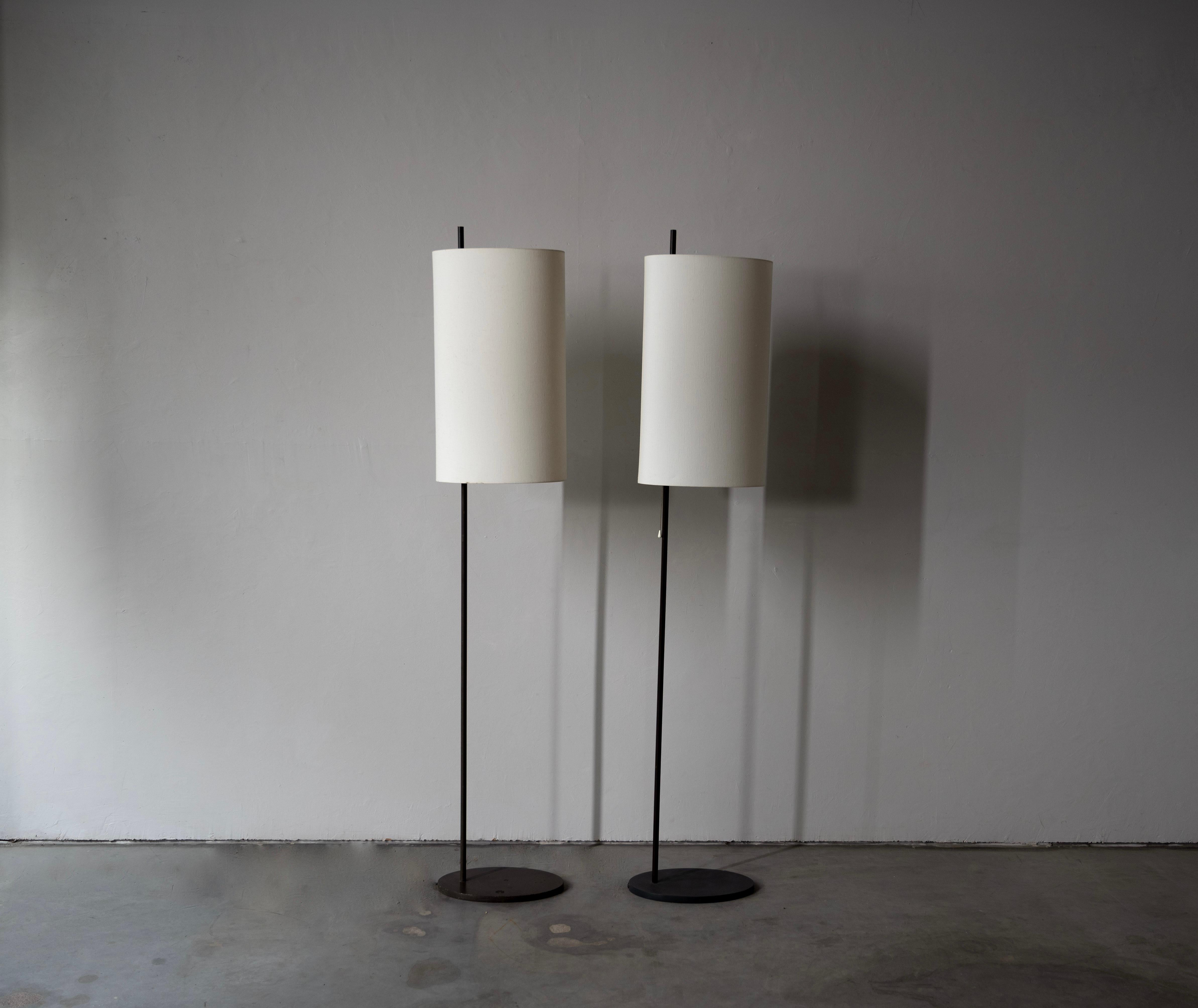 A pair of silk and steel, first edition floor lamps designed by Arne Jacobsen and produced by Louis Poulsen for the SAS Royal Hotel, Denmark, 1958.

This pair is from one estate, however note the color difference in lacquer to each lamp.
  