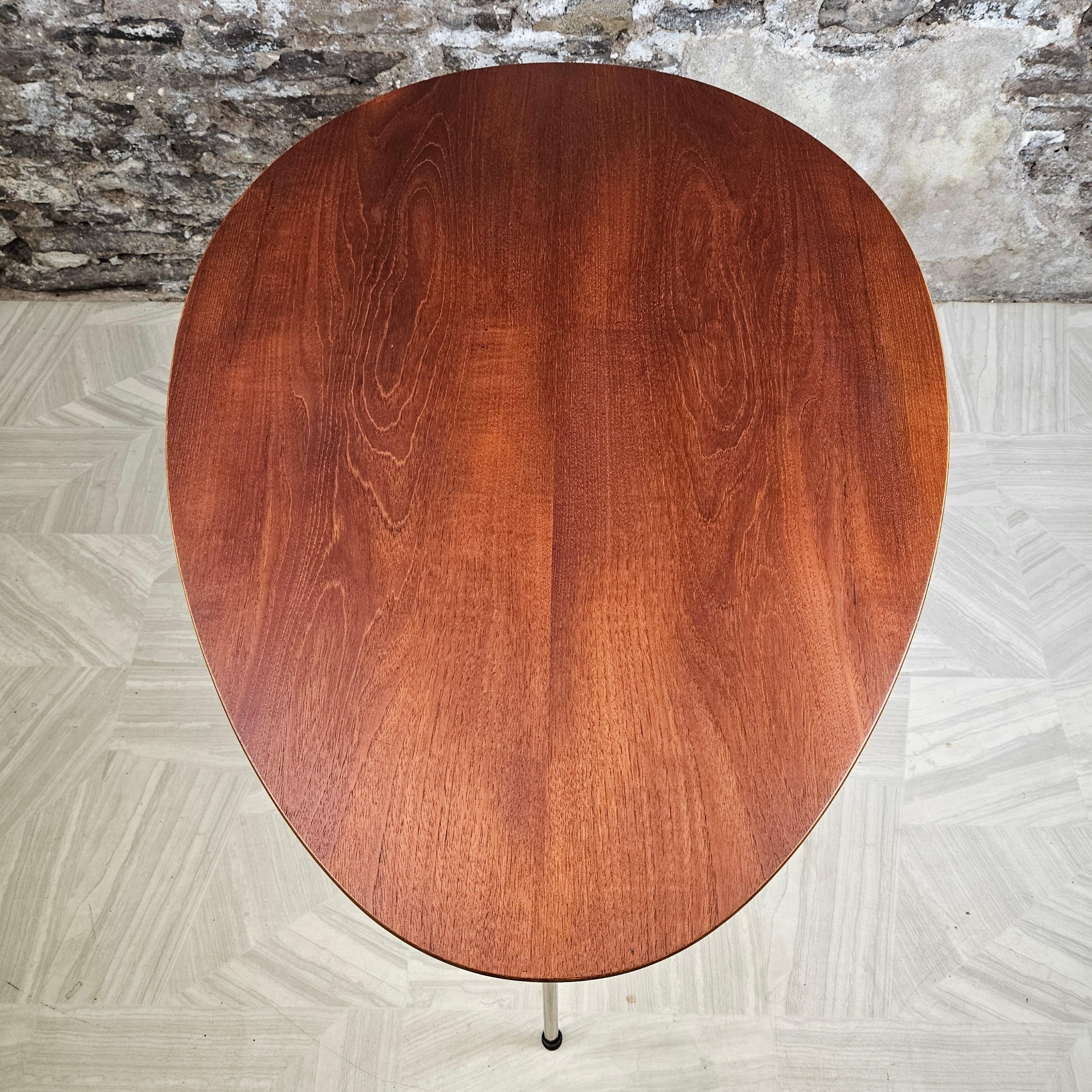Iconic mcm egg table by Arne Jacobsen for Fritz Hansen. Resting on three chromed steel legs, the elliptical design is equally purposeful as a kitchen or dining table in smaller spaces as it is in a home office. It fits seamlessly into any setting.