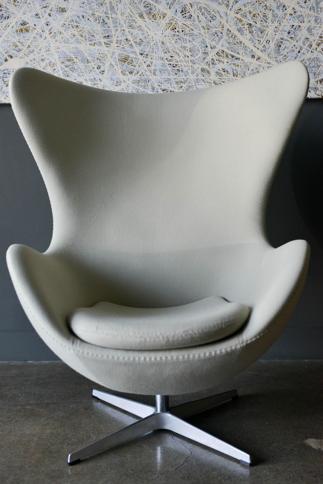 Original Arne Jacobsen for Fritz Hansen egg chair with desirable reclining mechanism. Originally designed in 1958, this is a 2008 production model. Beautiful neutral beige fabric in very good original condition with Hallingdal fabric. Base is
