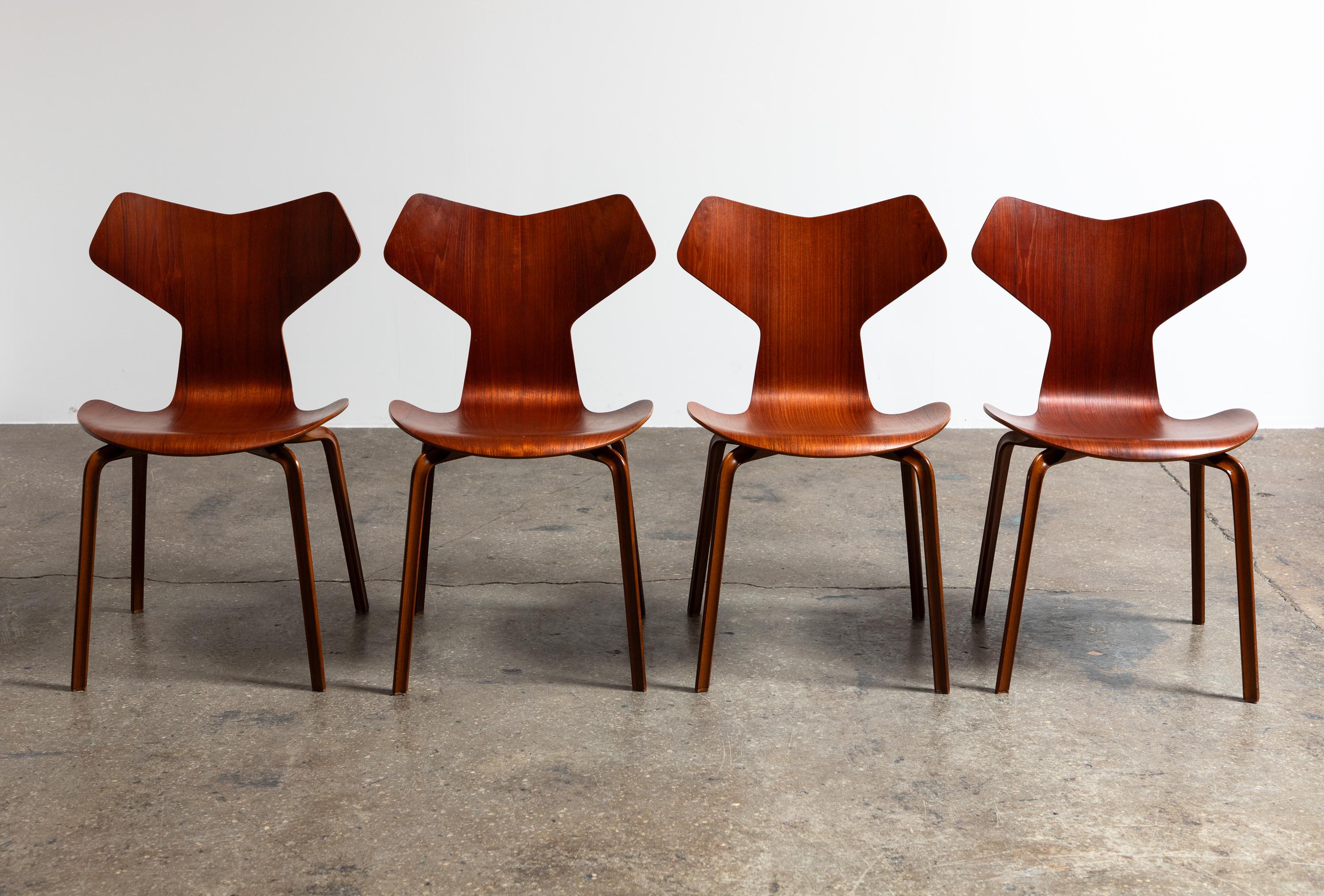 Stunning set of Grand Prix chairs designed by Arne Jacobsen for Fritz Hansen. Lightweight and comfortable, these chairs are in good vintage condition with beautiful warm teak wood selection throughout. Chairs have had very little prior use and their
