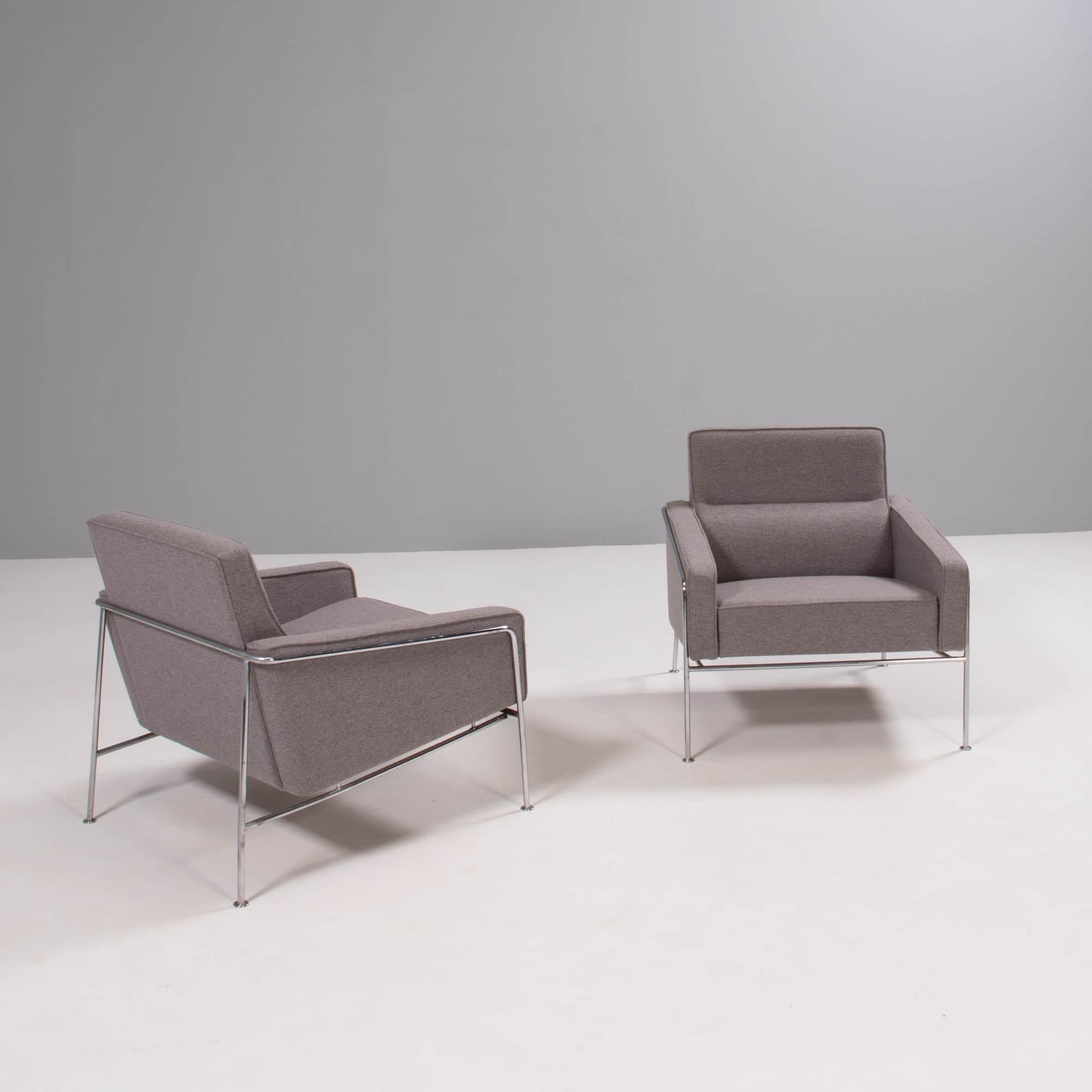Originally designed by Arne Jacobsen for the SAS Air Terminal in Copenhagen, the Series 3300 chair has a futuristic aesthetic.

Featuring a slim tubular chrome frame, the chairs are upholstered in grey fabric with angular armrests and a padded