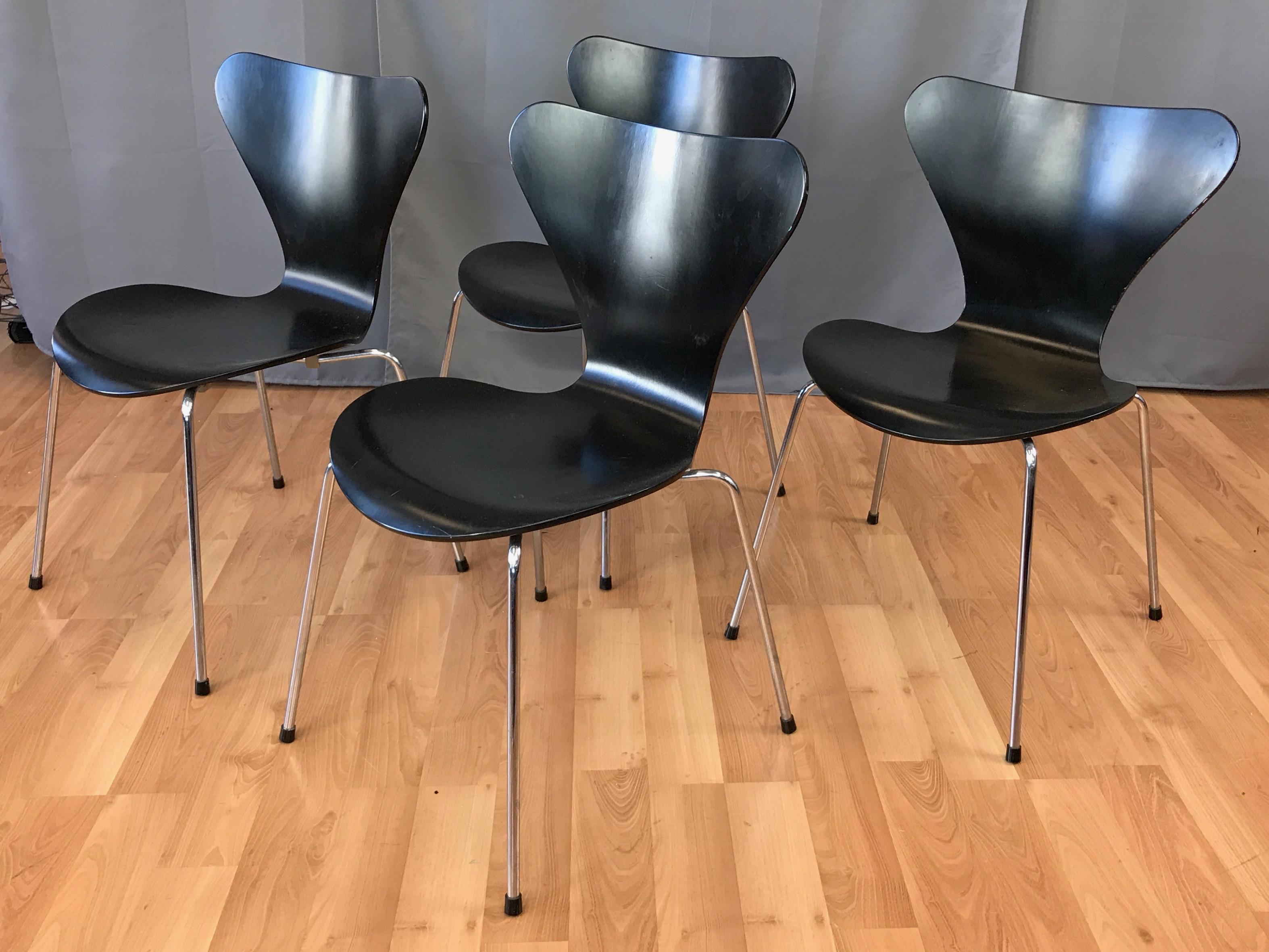 A set of four series 7 model 3107 stackable black lacquered side chairs designed by Arne Jacobsen for Fritz Hansen.

Instantly iconic upon their introduction in 1955, with this particular set having been produced in 1993. Comfortable bentwood seat