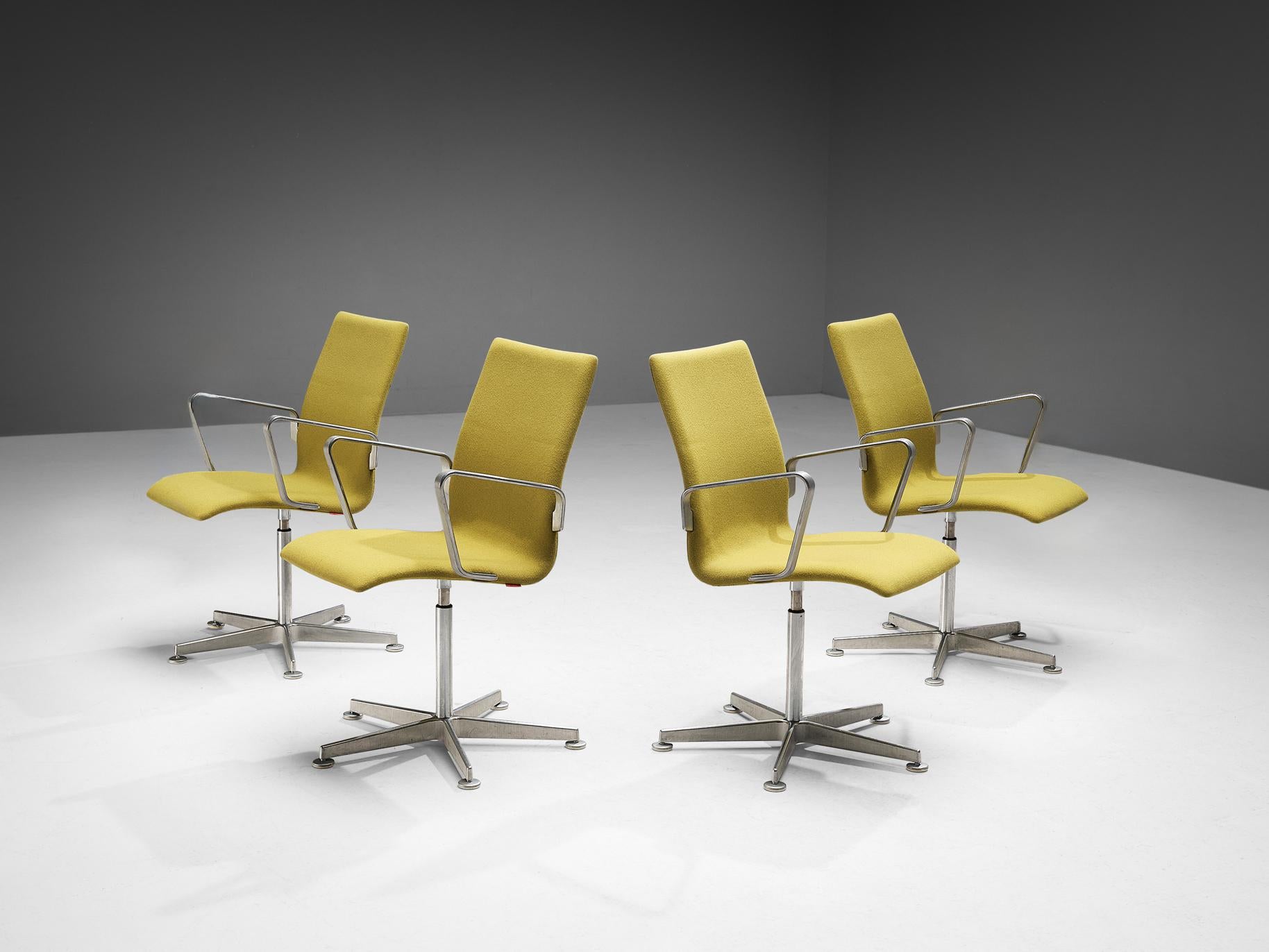 Arne Jacobsen for Fritz Hansen, set of four 'Oxford' chairs, metal, yellow fabric, Denmark, design 1965, later production

These classic executive office chairs feature a medium high back (as opposed to the models with a low and a very high back),