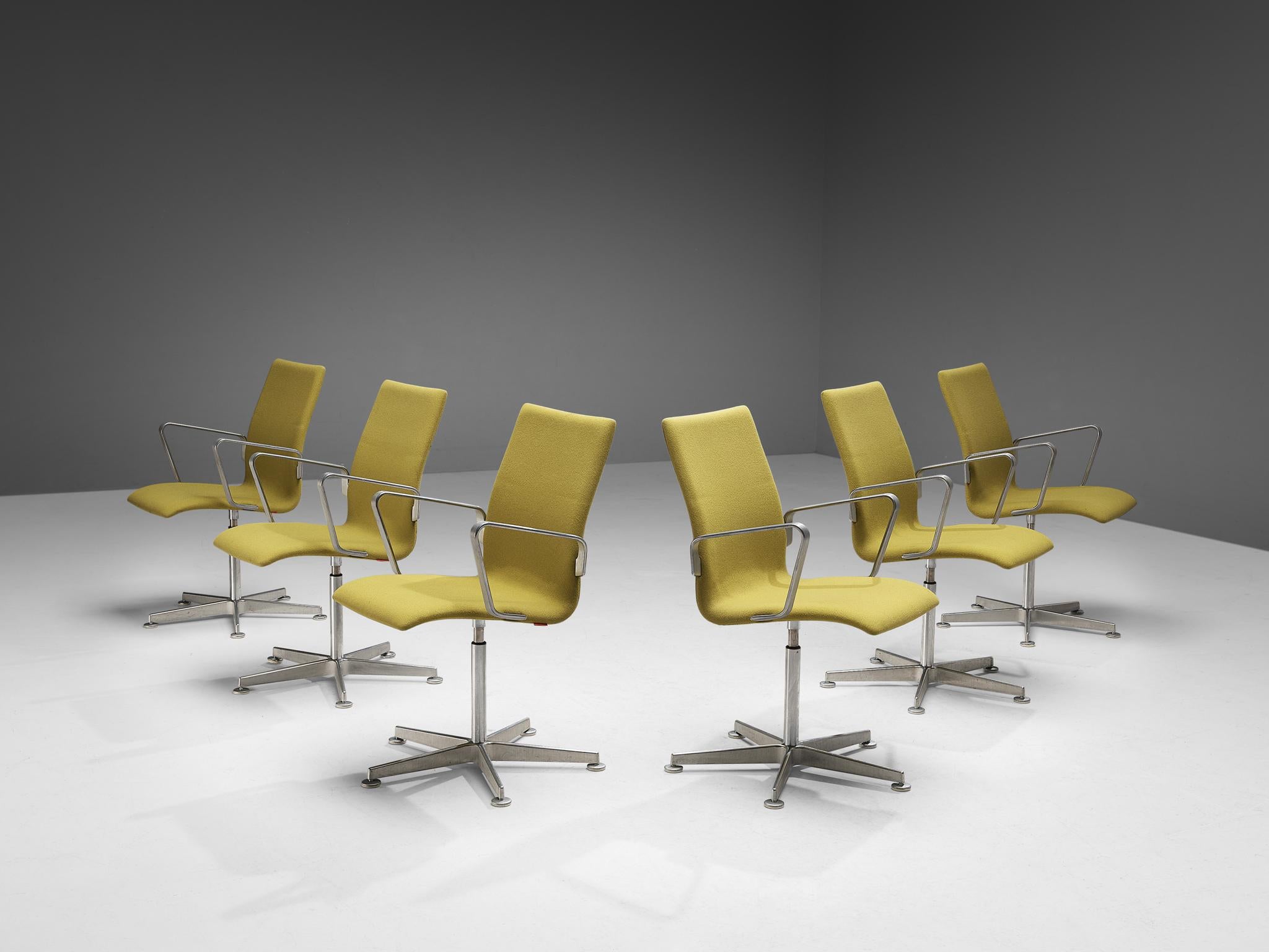 Arne Jacobsen for Fritz Hansen, set of eight 'Oxford' chairs, metal, yellow fabric, Denmark, design 1965.

These classic executive office chairs feature a medium high back (as opposed to the models with a low and a very high back), swivel