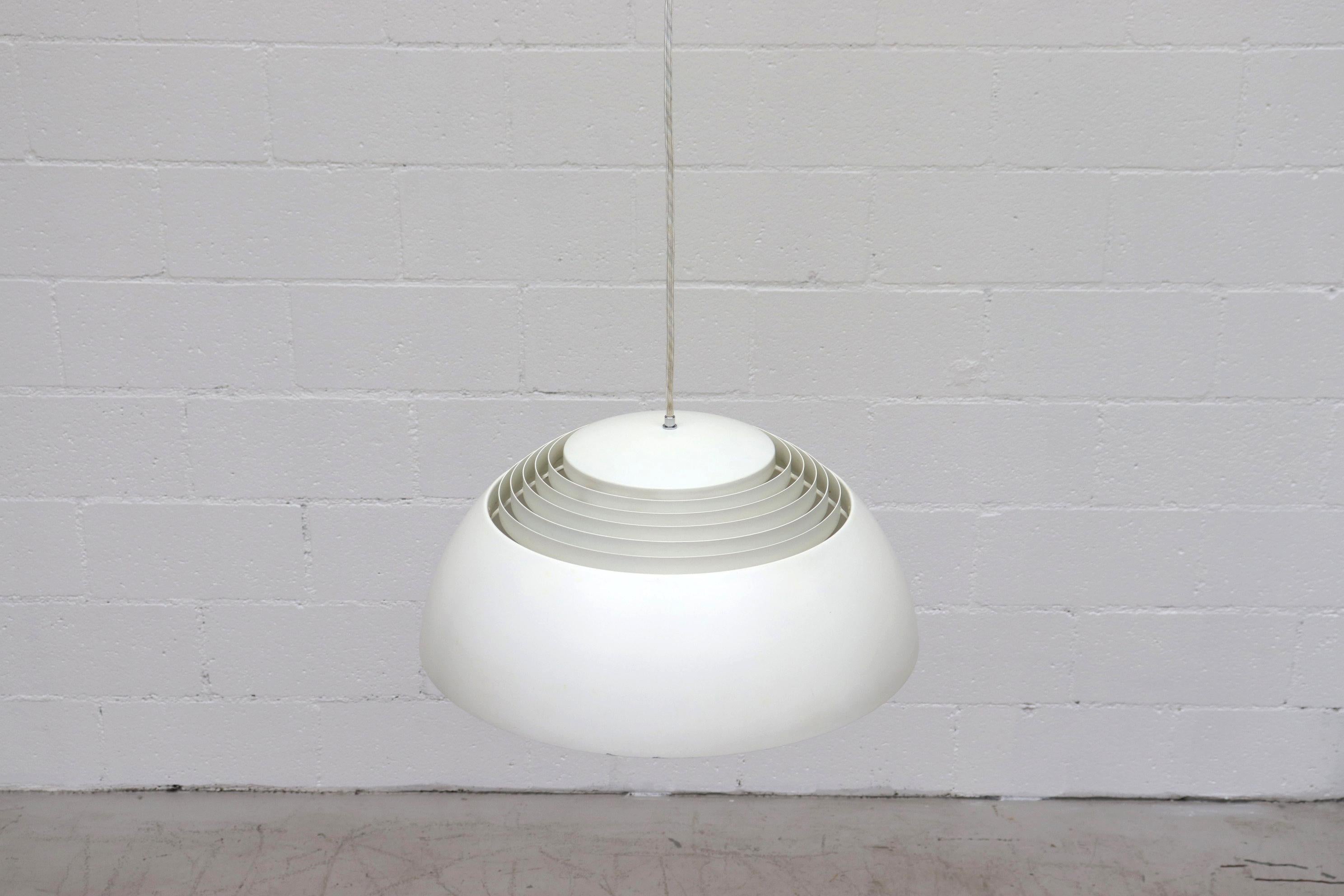 Large White Enameled Metal Vented Dome Light with Inner Trumpet Shaped Diffuser and a Cloth Covered Light Cord. A.J. Royal Pendant Lamp by Arne Jacobsen for Louis Poulsen, Danish Design 1957. In Original Condition with Wear Consistent with Age.