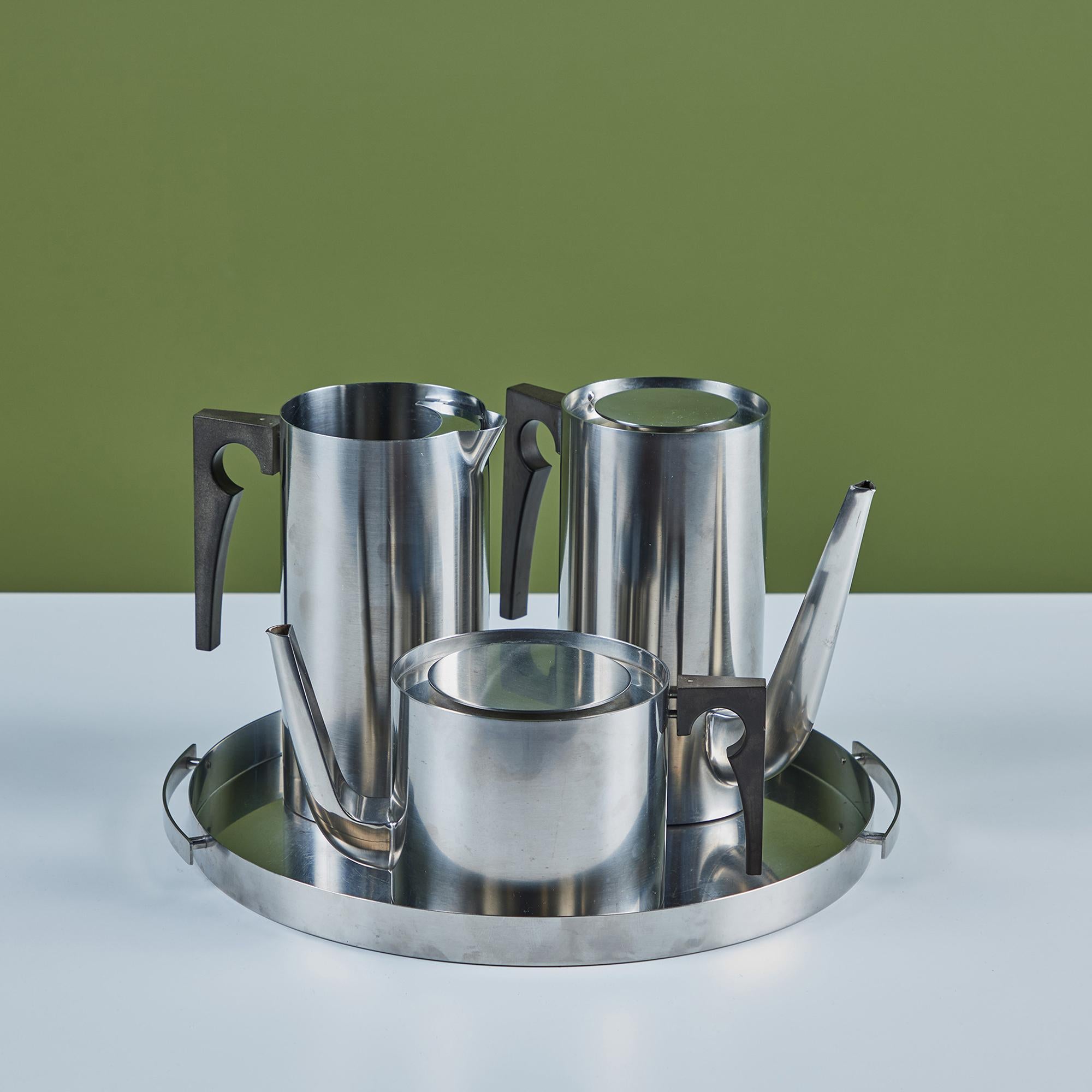 Four-piece stainless steel coffee and tea service set by Arne Jacobsen for Stelton, c.1960s, Denmark. The set includes a coffee pot, tea pot, pitcher and round rimmed tray with handles.
Stelton imprinted on the underside.

Dimensions
Coffee Pot: 9