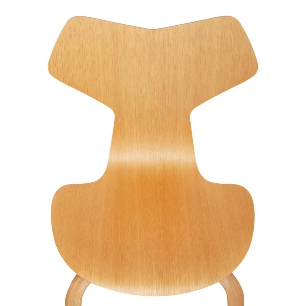 Arne Jacobsen Grand Prix of oak wood. The chairs are all from 2014 and thus in the same patinated condition with small marks and chips, primarily on the legs.