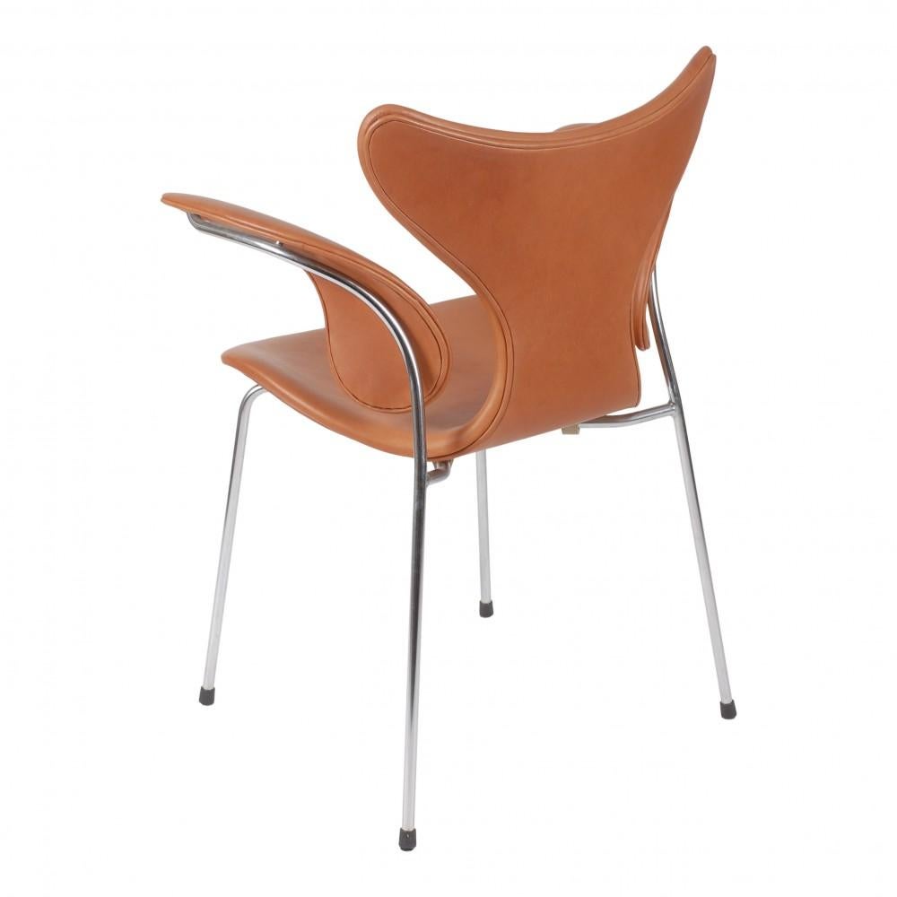 Danish Arne Jacobsen Lily armchair, 3208 newly upholstered with cognac aniline leather For Sale