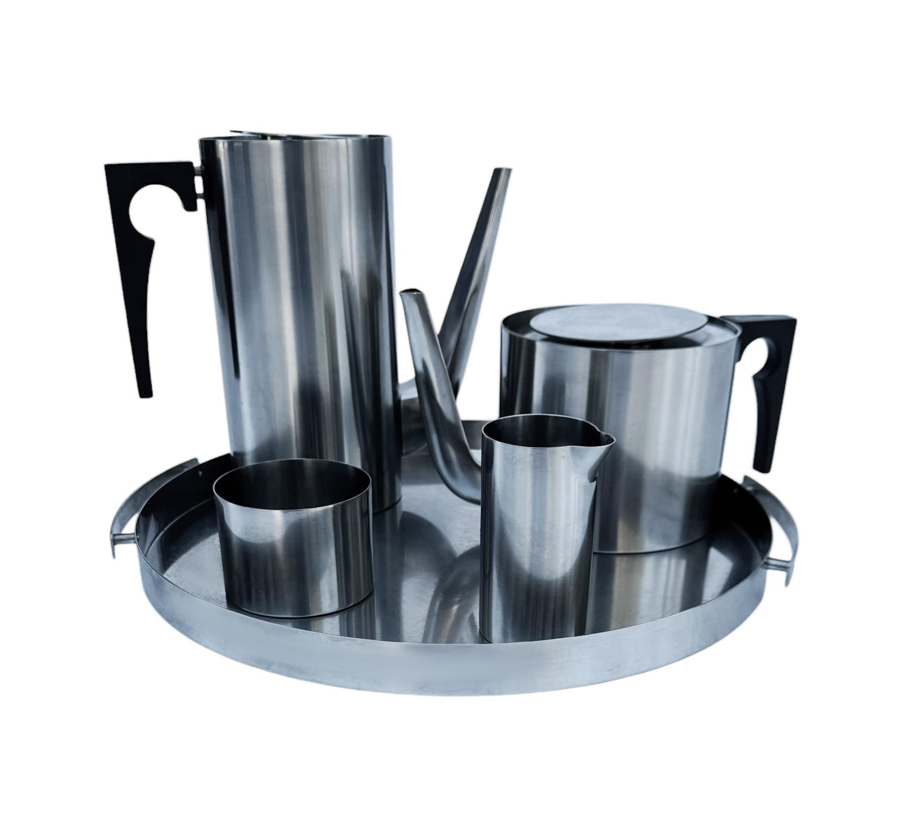 A vintage tea set by Arne Jacobsen from Denmark circa 1960s. It features all stainless steel and Bakelite construction. Comes with all of the pieces shown and sold as a set. 