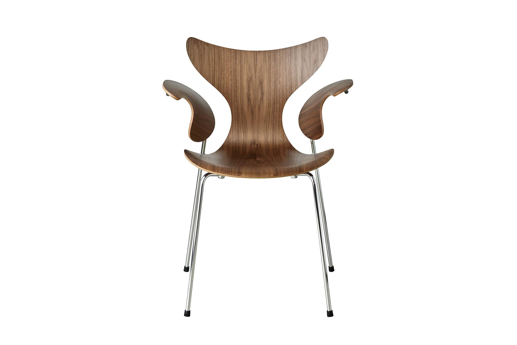 The Lily was originally designed for the Danish National Bank. The first model was 3108 from 1968, and the chair was introduced to the market with arms, model 3208, at the Danish Furniture Fair in 1970. The chair is made from laminated sliced veneer