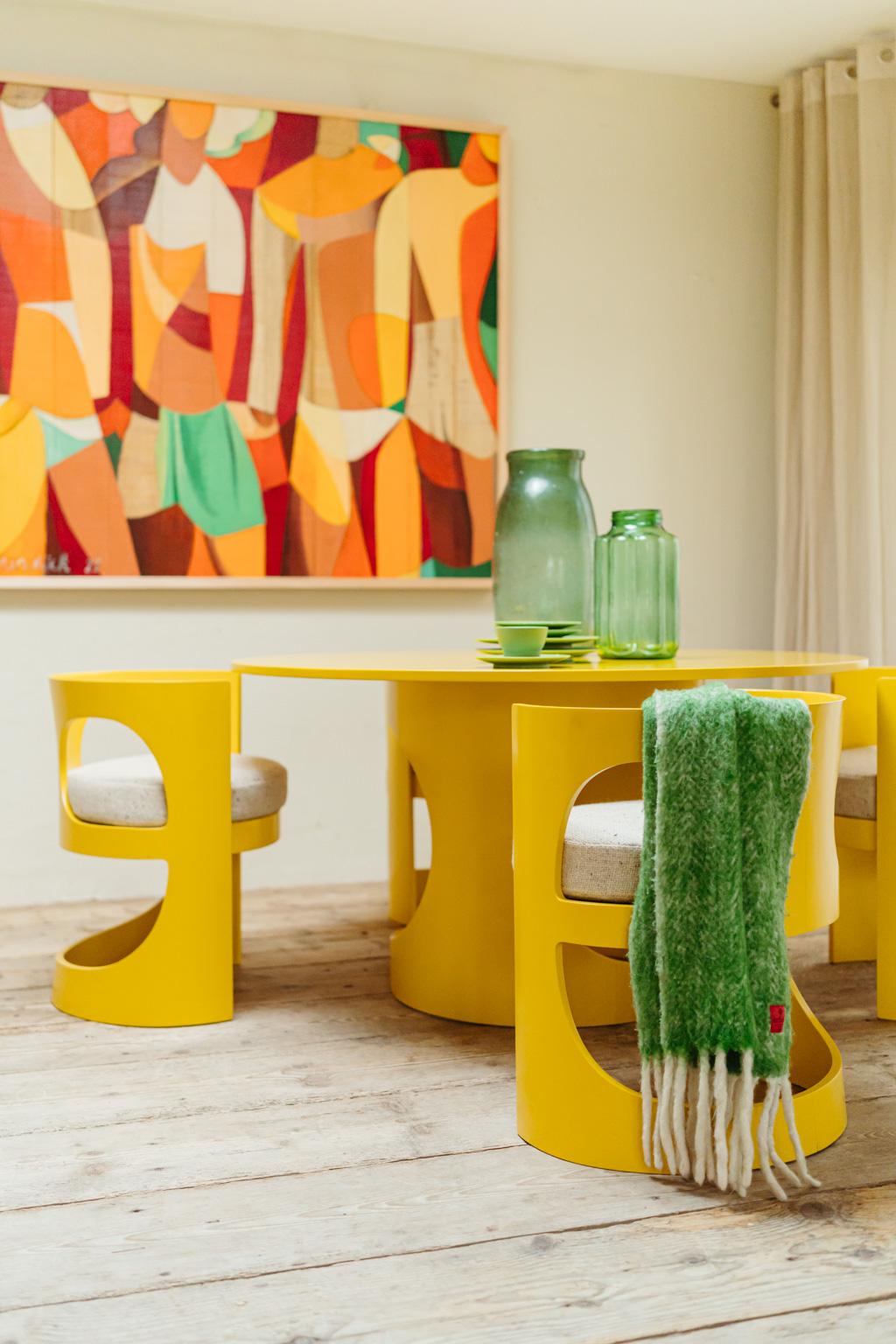 A rare dining room set consisting of one round table with four matching chairs.
Designed in 1969 by Arne Jacobsen, this is one of his last creations. Made of vibrant yellow lacquered birch plywood manufactured by Asko in Finland. The chairs base is