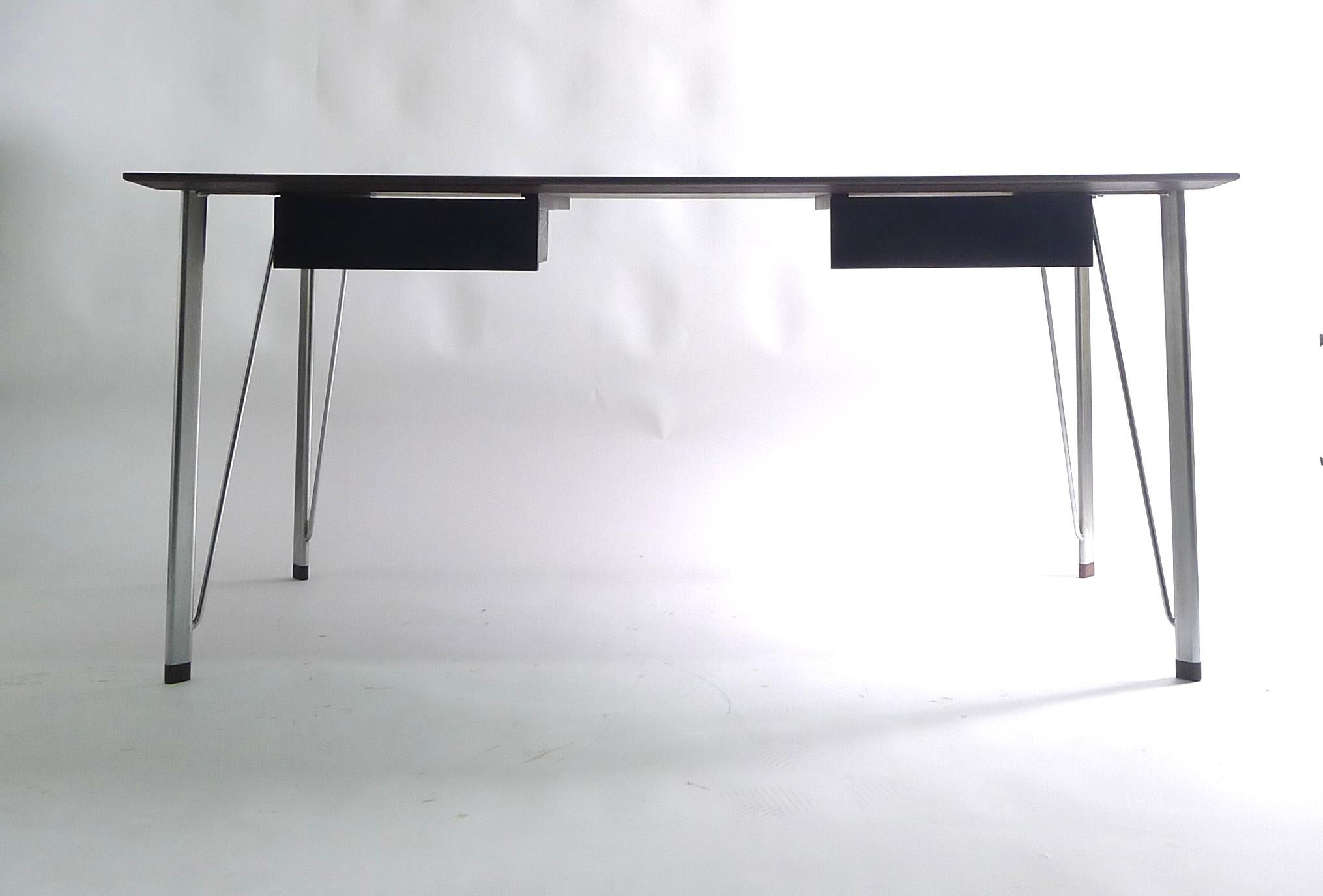 Arne Jacobsen, FH 3605 writing desk, designed 1955 and made by Fritz Hansen, Denmark, in rosewood with detachable aluminium legs with oval rosewood caps. Fitted two drawers to one side. Remnants of Fritz Hansen label just visible to