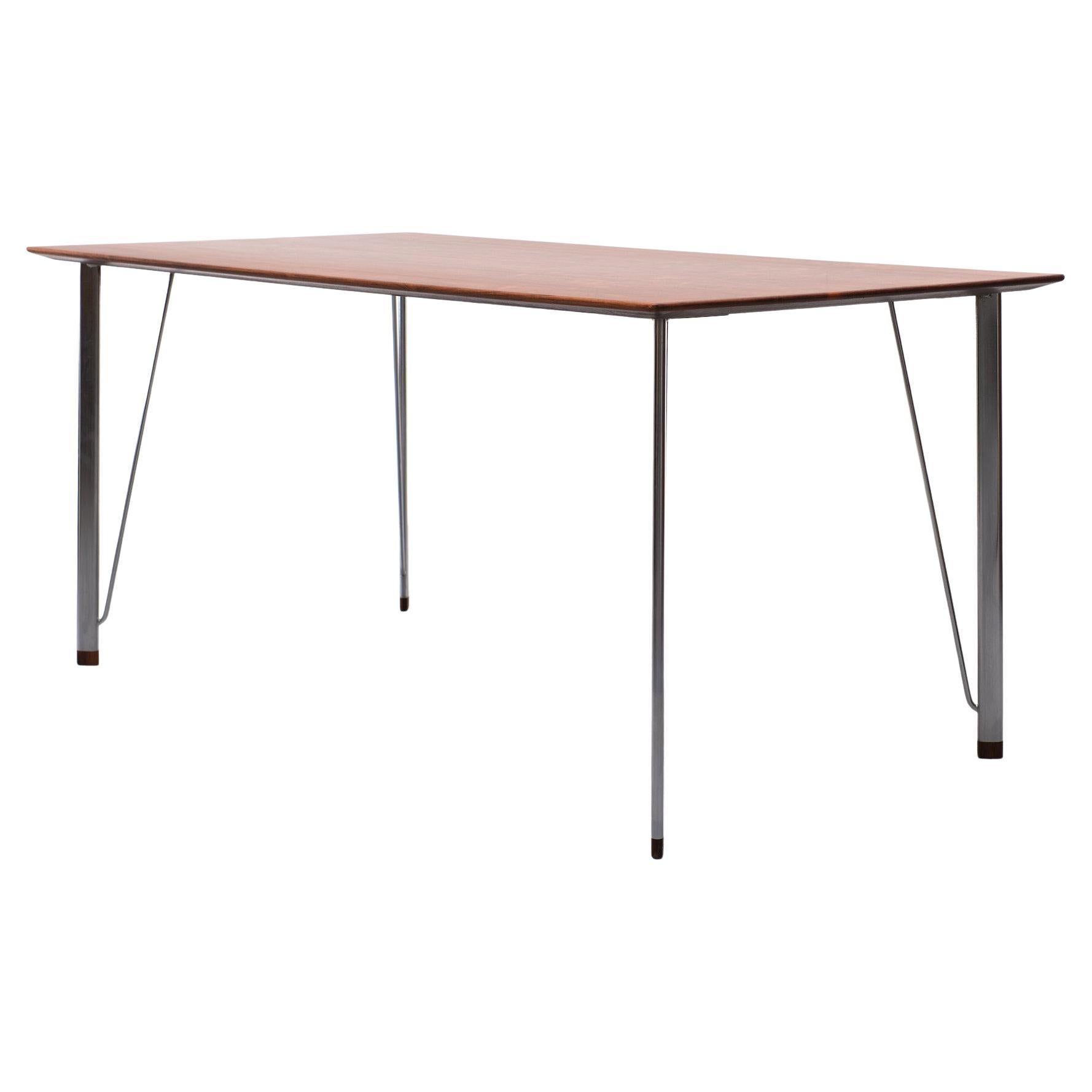 Beautiful  Rosewood working table .Model 3605  1950s  
Design by Arne Jacobsen for Fritz Hansen . Nice thin top
on elegant polished Metal legs . solid Rosewood feet . 