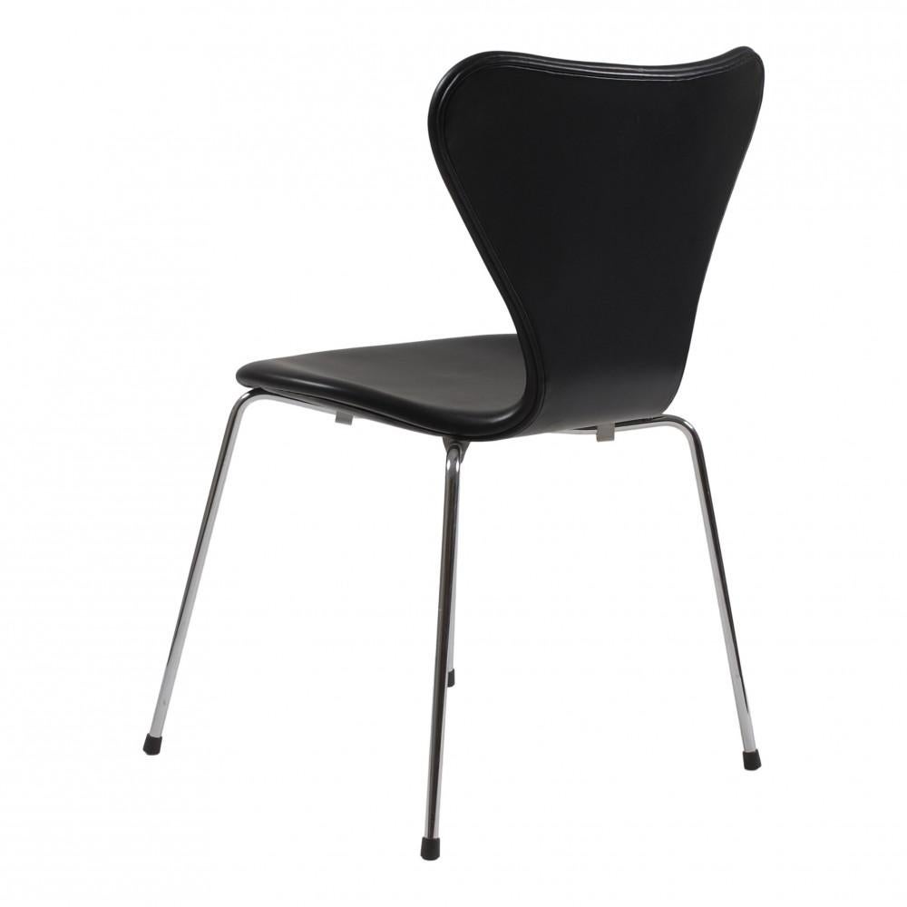 100 chairs in stock!
These seven chairs are used and are newly upholstered with black classic leather and fitted with a new foam cushion. 

The chairs have solid backs and no defects. The chairs are original and manufactured by Fritz Hansen. The