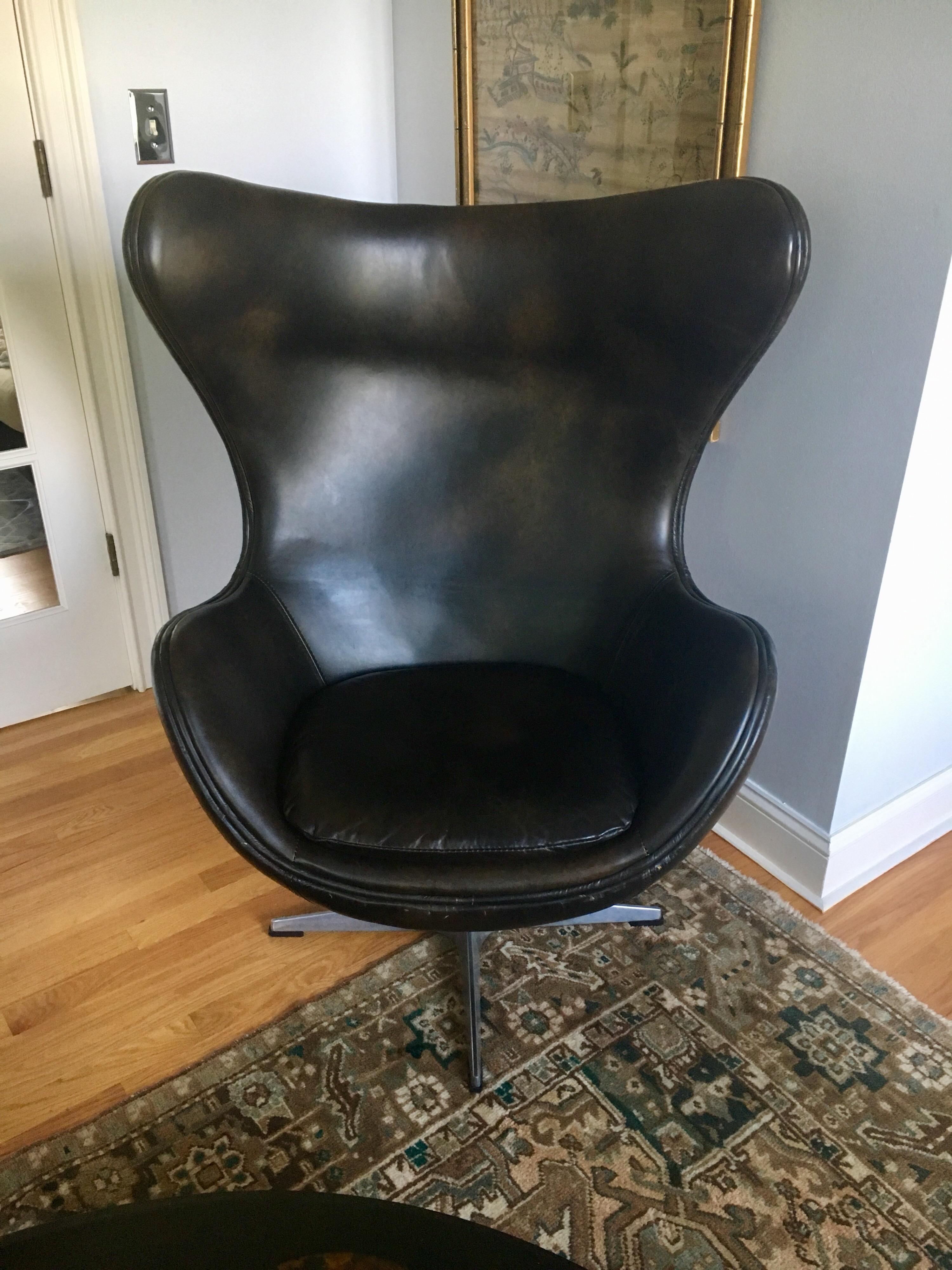 Arne Jacobsen style soft leather and aluminum classic egg chair. We do not see any hallmarks and chair is in mint condition from the 1970s. Chair swivel and rocks back.