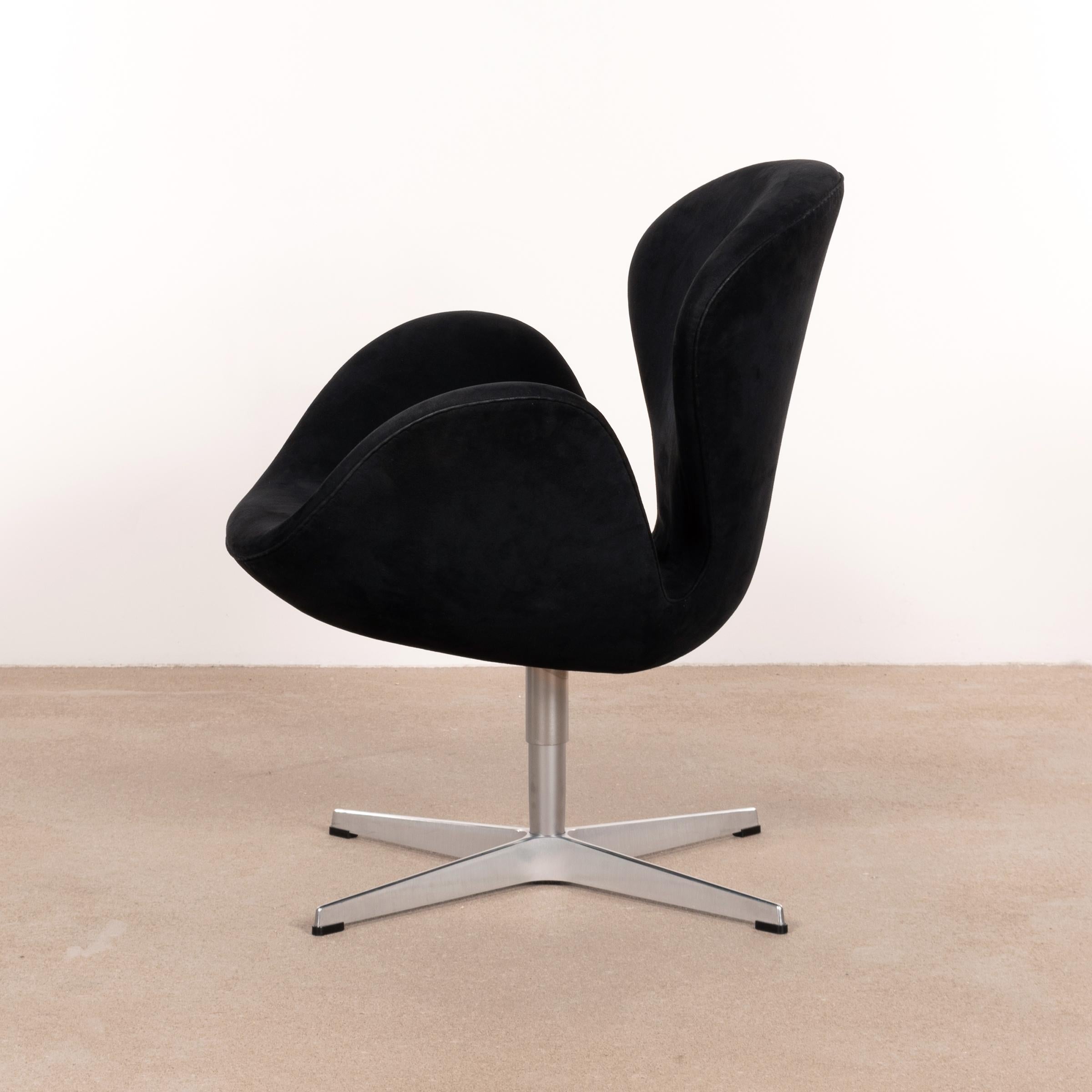 Iconic Swan chair designed by Arne Jacobsen for the lobby and lounge areas at the SAS Royal Hotel in Copenhagen 1958. This Swan Chair is upholstered in original black Alcantara and produced in 2004 (signed). Very good condition with only minor