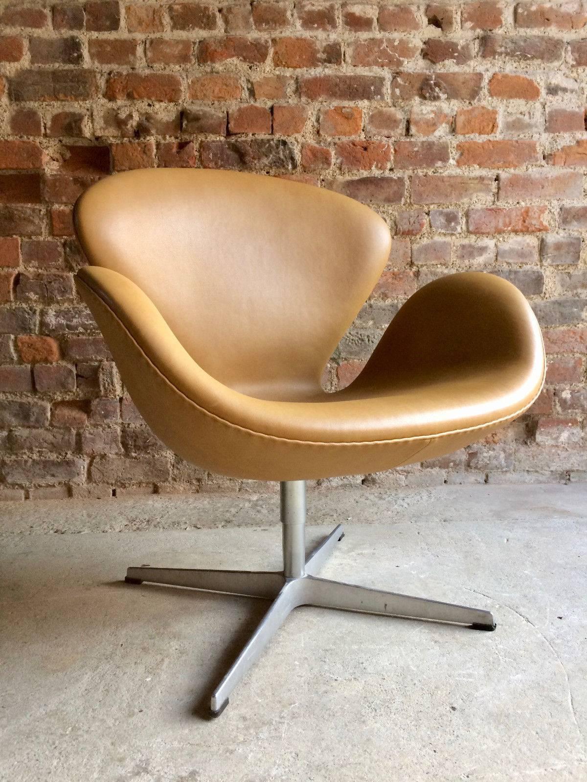 A Swan chair designed by Arne Jacobsen and manufactured by Fritz Hansen 2007, soft mustard  leather hide with steel base, makers label under seat, stamped under base.

Arne Jacobsen designed the Swan as well as the Egg for the lobby and lounge areas
