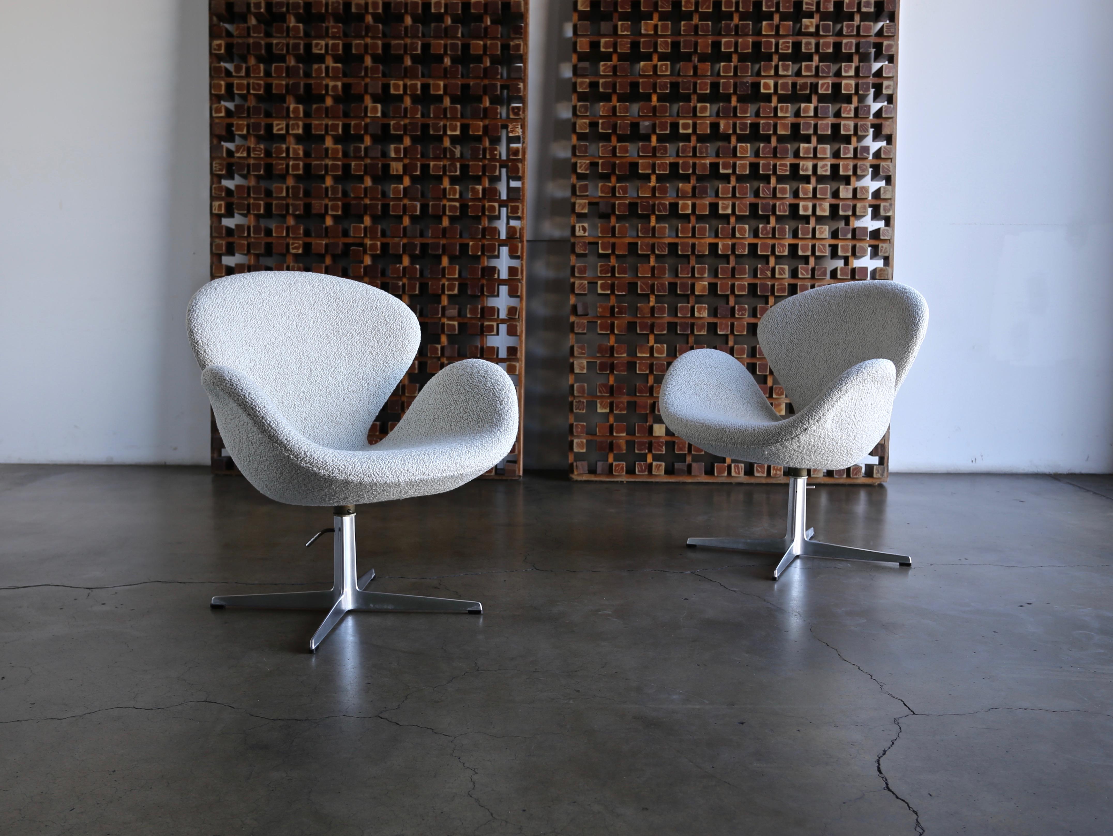 Arne Jacobsen Swan chairs for Fritz Hansen circa 1960. The upholstery has been restored. The bases are in original condition.