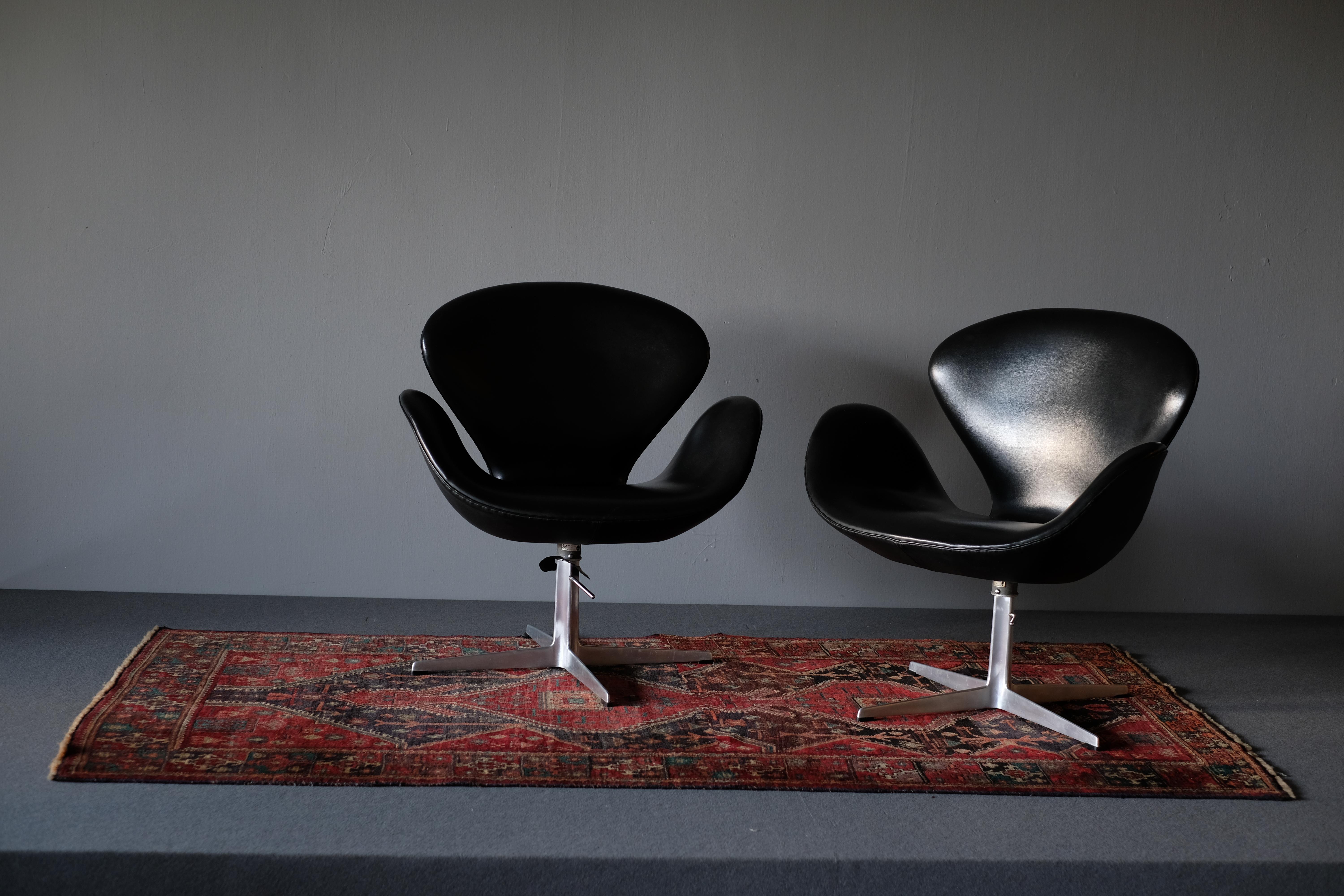 A very rare matching set of 3 Swan lounge chairs model 3320. Designed by Arne Jacobsen for the SAS Royal Copenhagen Hotel which opened in 1960. It is produced by Fritz Hansen. Each chair is upholstered in patinated black Skai which is not in