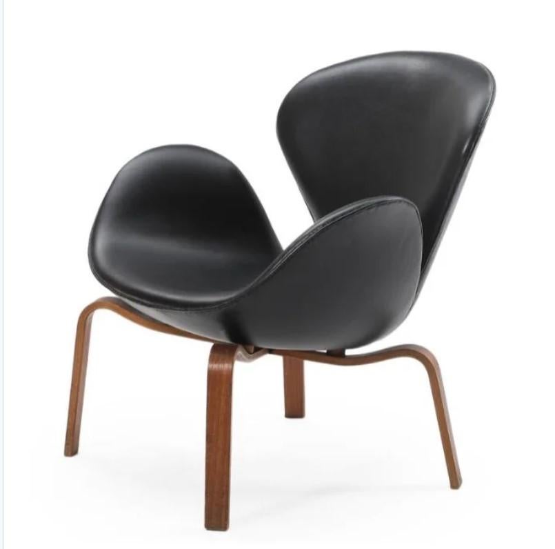 Produced for a short period and limited to distribution to Denmark, the plywood wood leg variation of the Swan chair, model 4325 is very rare. The uncommon wood variation of the Swan chair was introduced to fit more easily within traditional
