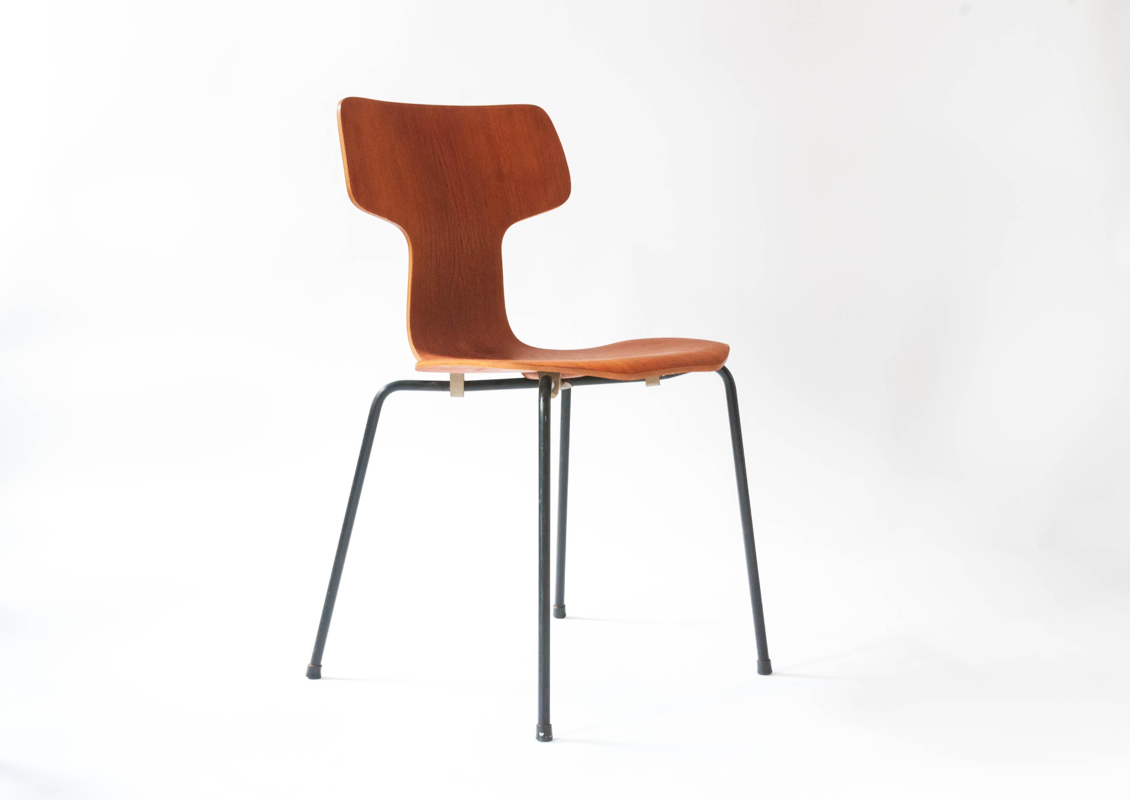 Early 1950 production model 3103 chair by Arne Jacobsen for Fritz Hansen. Features seats made out of teak and black lacquered wrapped foiled legs. Would make a great side chair or desk chair. The back rest does not support a lot of weight due to
