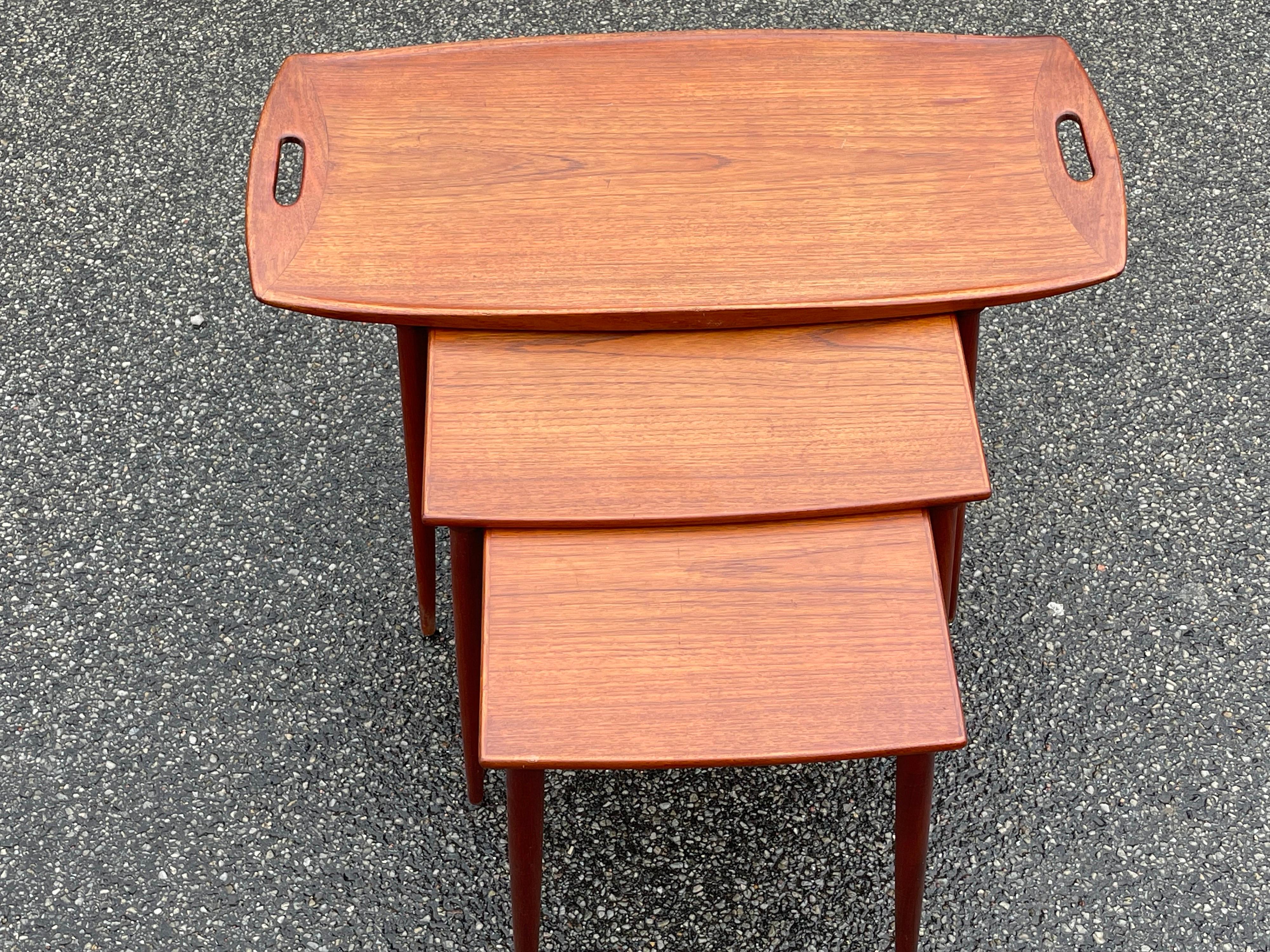Danish No. 8 teak Nesting Tables by A. Jakobsen for Poul Jeppesens Møbelfabrik, 1960s, This set of nesting tables with tapered legs was designed in 1964. The largest table is in the form of a tray with a raised edge. These are truly some beautiful