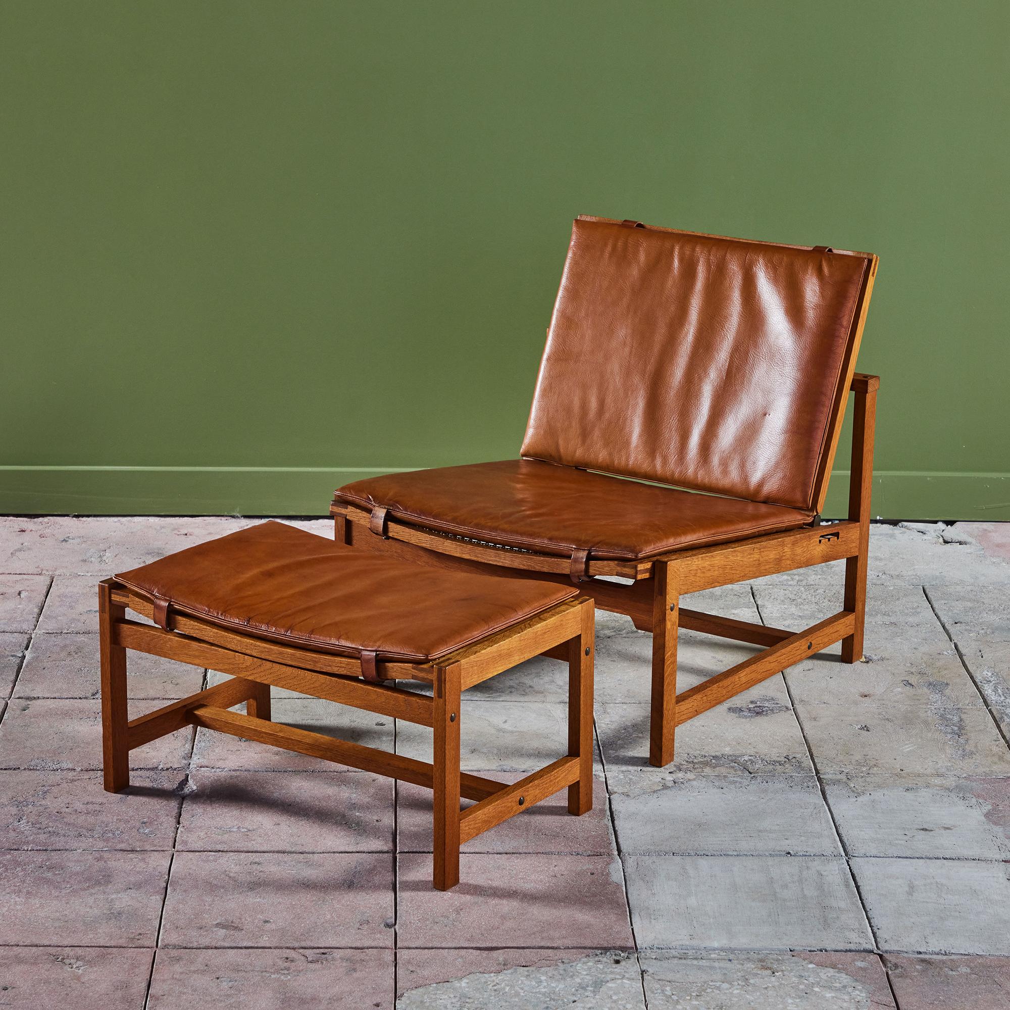 Oak and leather lounge chair and ottoman set by Arne Karlsen and Peter Hjort, for Interna, c.1960s. The chair features an adjustable seat back and an oak frame. The cane lounge chair and ottoman both have the original cognac leather