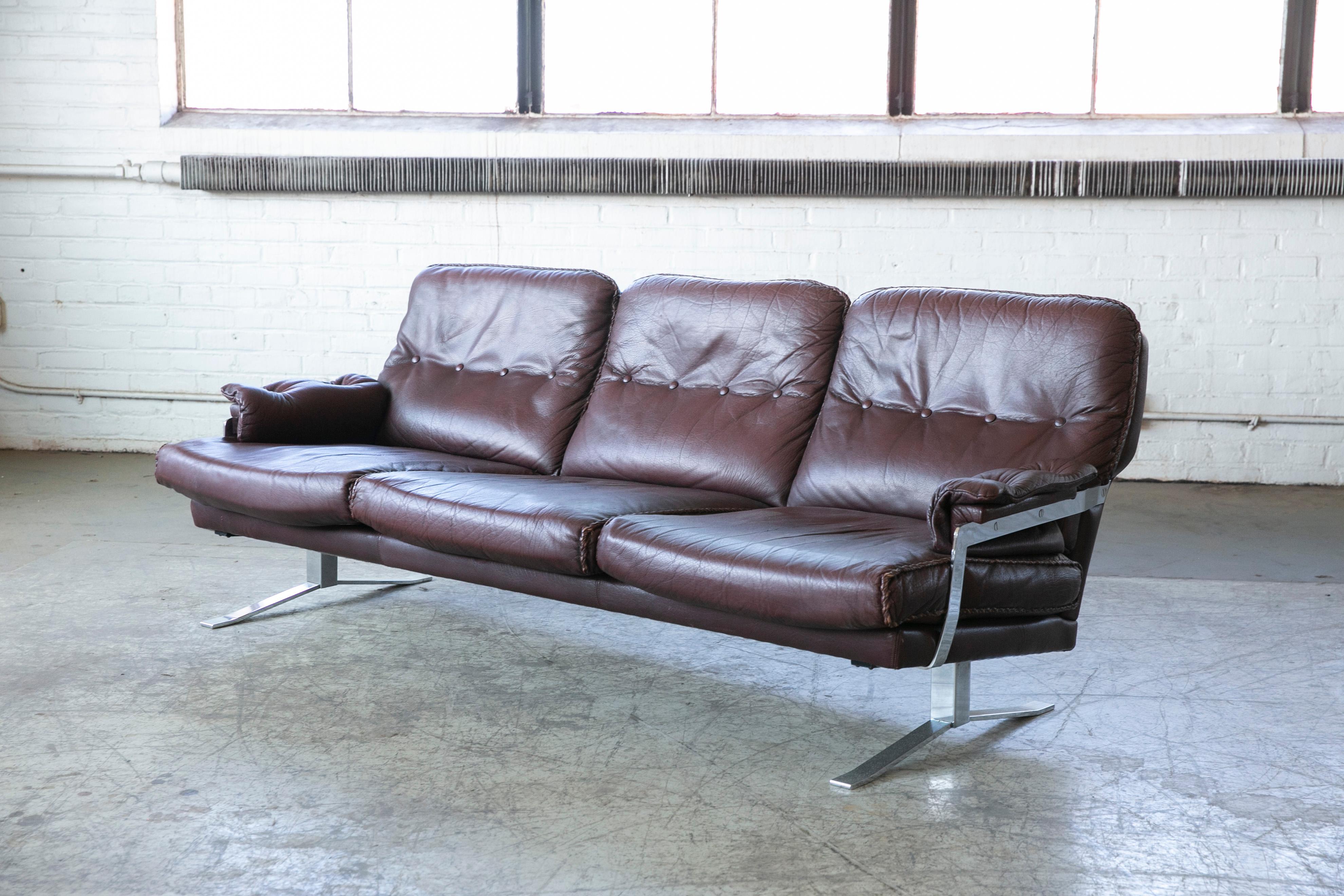 A sofa in chocolate brown buffalo leather and chrome base with fabulous whipstitch trim, designed by Arne Norell for Vatne Møbler of Norway and produced in the late 1960's or early 1970's. Very cool design. Buffalo hide wears and ages very well and