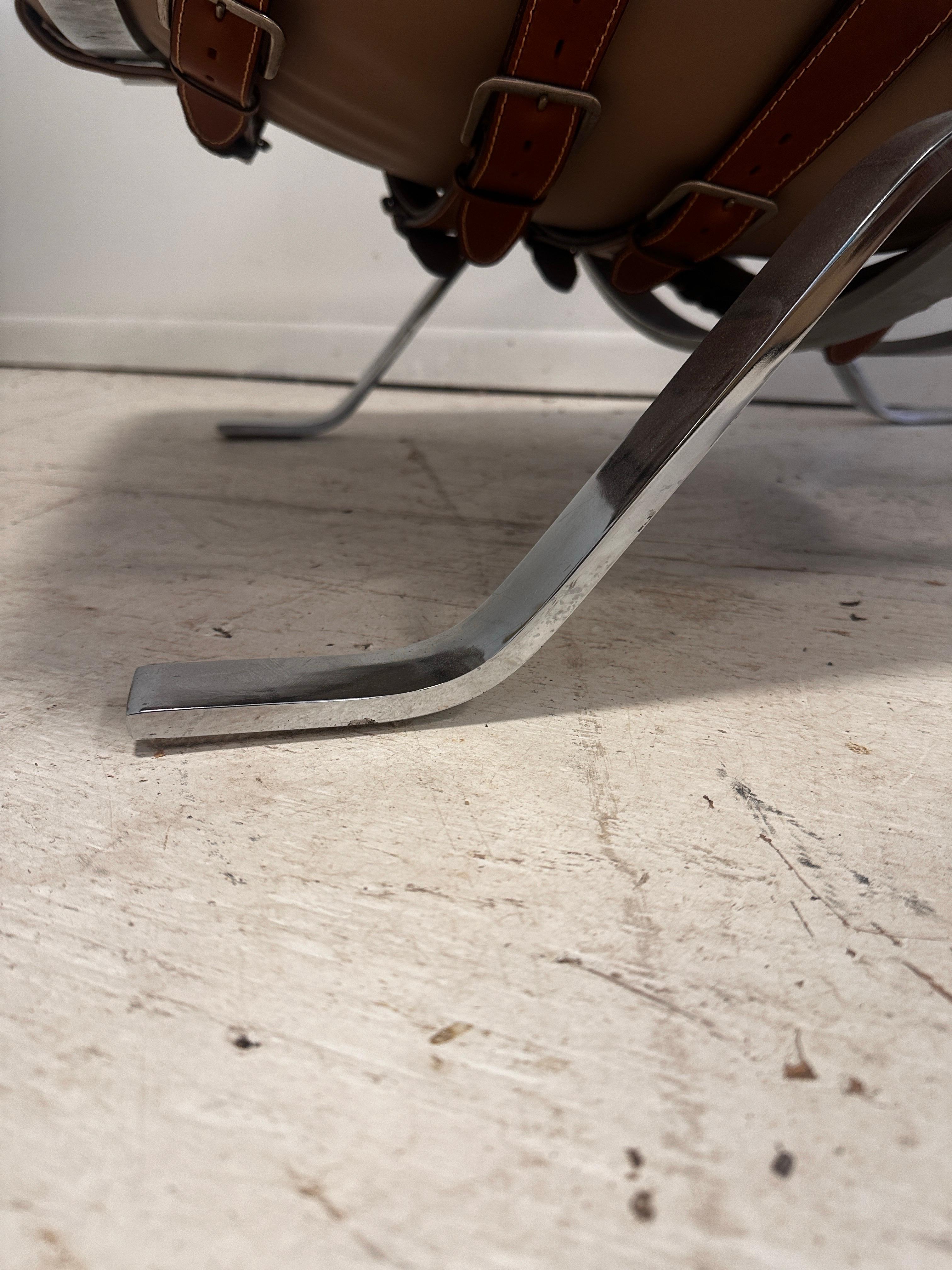 Iconic and the most coveted of any chrome flat bar chairs, showing labor intensive thick leather straps on back that rival any Louis Vuitton luggage. Sleek, visually small profile, known for Swedish ergonomic comfort. 

Extremely difficult to find