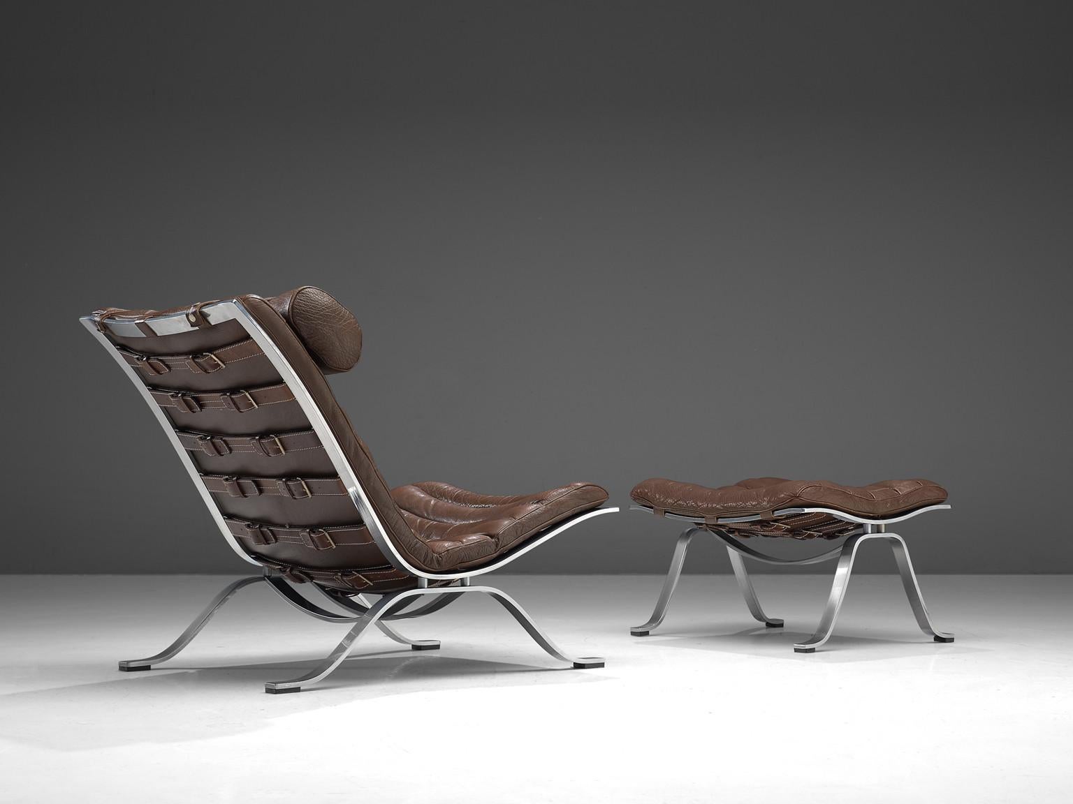 Arne Norell for Norell Møbel AB, 'Ari' lounge chair and ottoman, brown leather, chrome-plated steel, Sweden, 1966

This lounge chair is designed by Arne Norell. This chair, model Ari, comes with a footstool. The whole frame is executed in