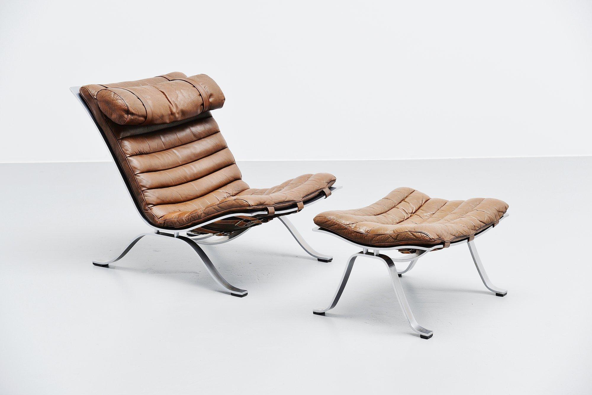 Beautiful and very comfortable lounge chair with ottoman designed by Arne Norell and manufactured by Norell Mobler AB, Sweden, 1966. This lounge chair set has a solid steel chrome plated frame, leather belts to support the brown leather cushions.